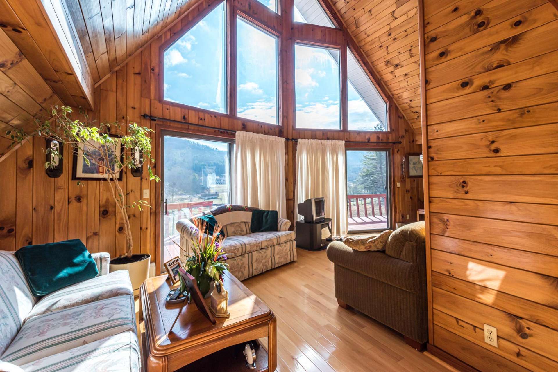 As you enter the home, to the left is the vaulted living area with a wall of windows capturing the views and filling the room with natural light.