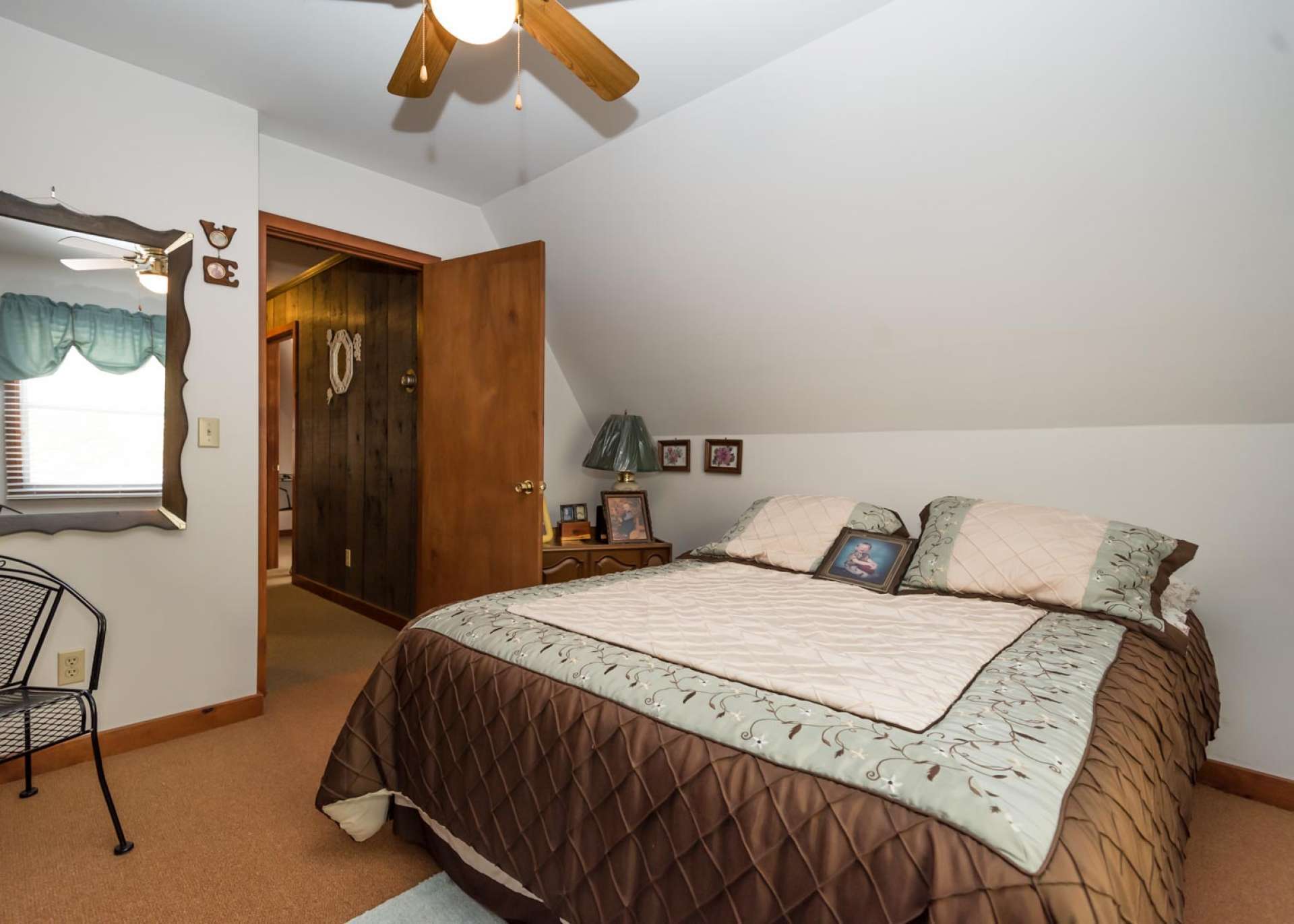 This upper level bedroom is spacious with double closets and warm carpeted flooring.