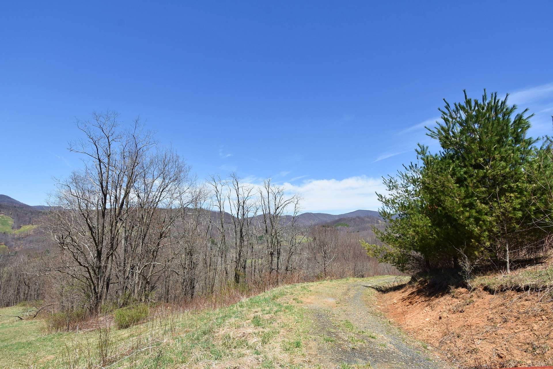 A graveled drive winds through the acreage along beautiful ridges and woodlands.