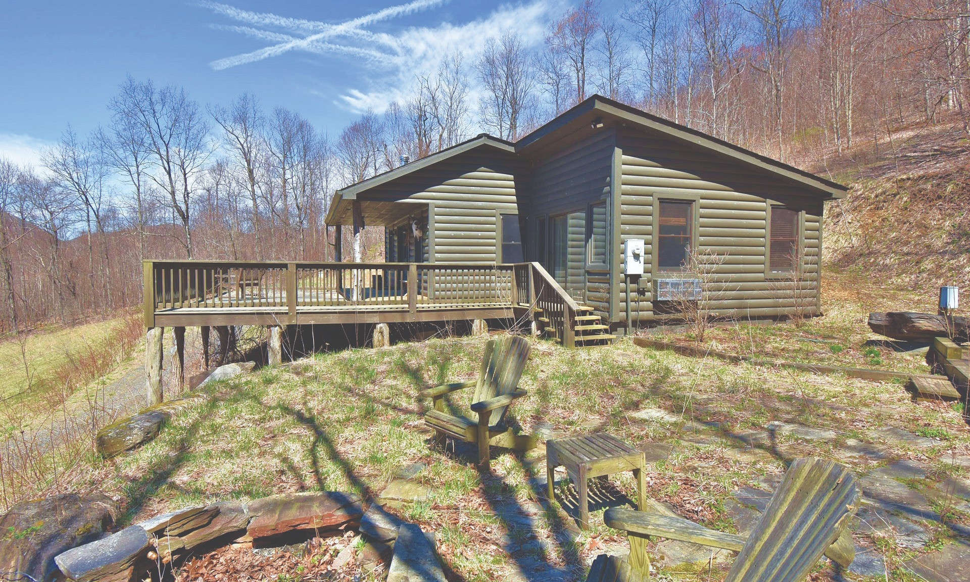 Enjoy outstanding sunsets and long range mountain views from the deck of this sweet cabin hidden away on a 110 acre setting in the Todd area of Southern Ashe County.