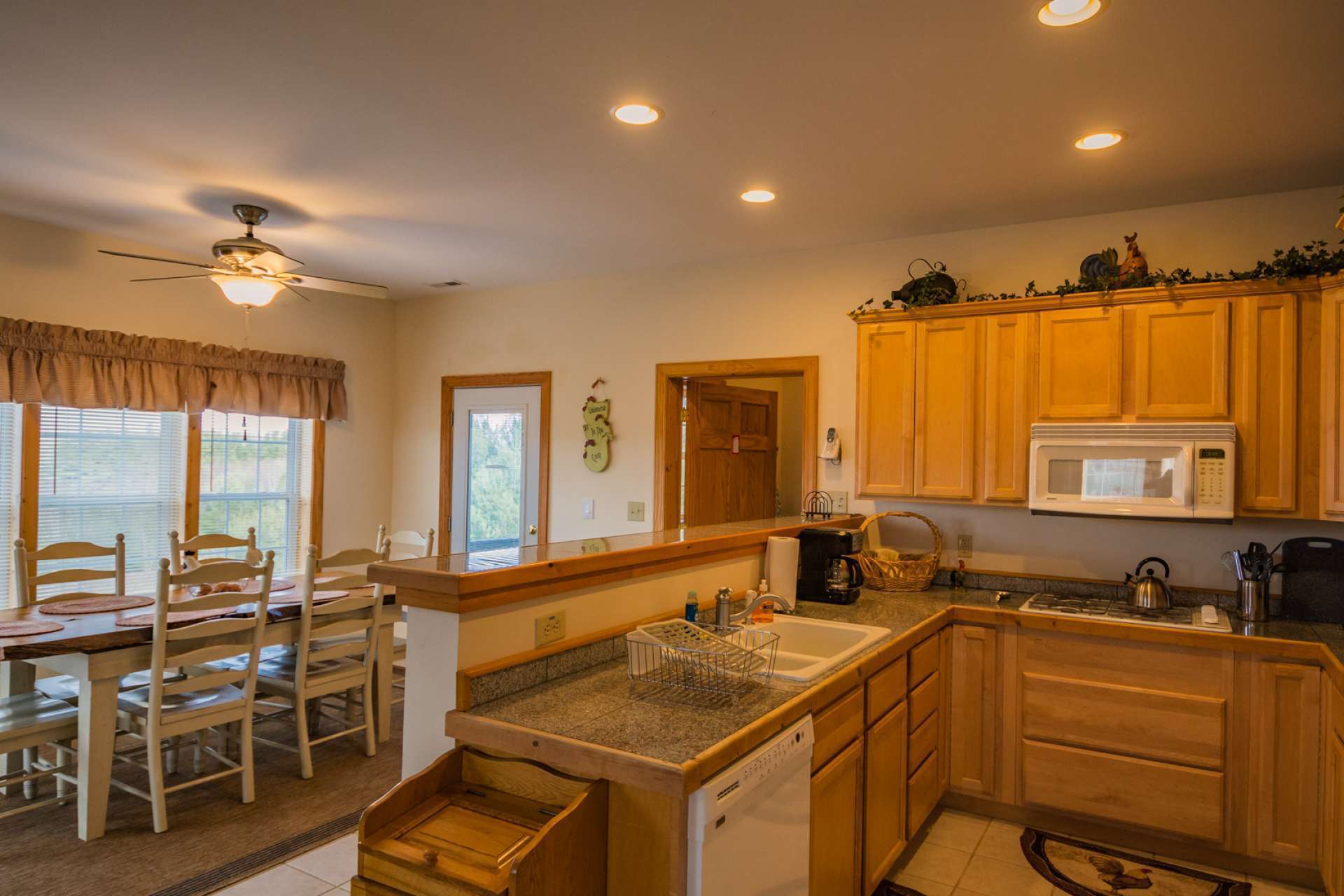 Just off the kitchen is the laundry area with additional storage space, and access to the private deck with hot tub.
