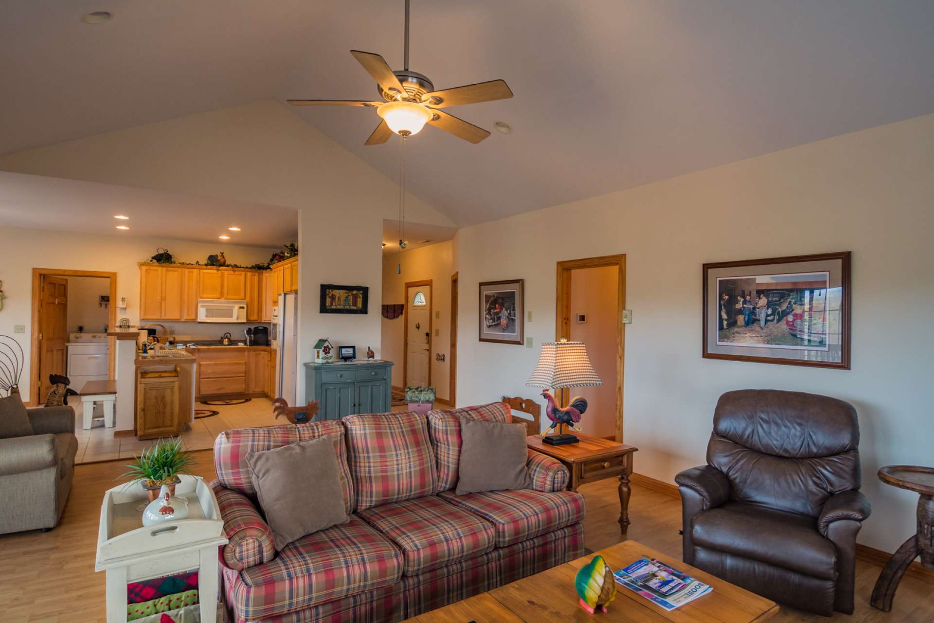 The open floor plan offers convenient transition from the living area to the kitchen and dining areas, and also keeps the host or hostess involved in conversation while preparing the meal.