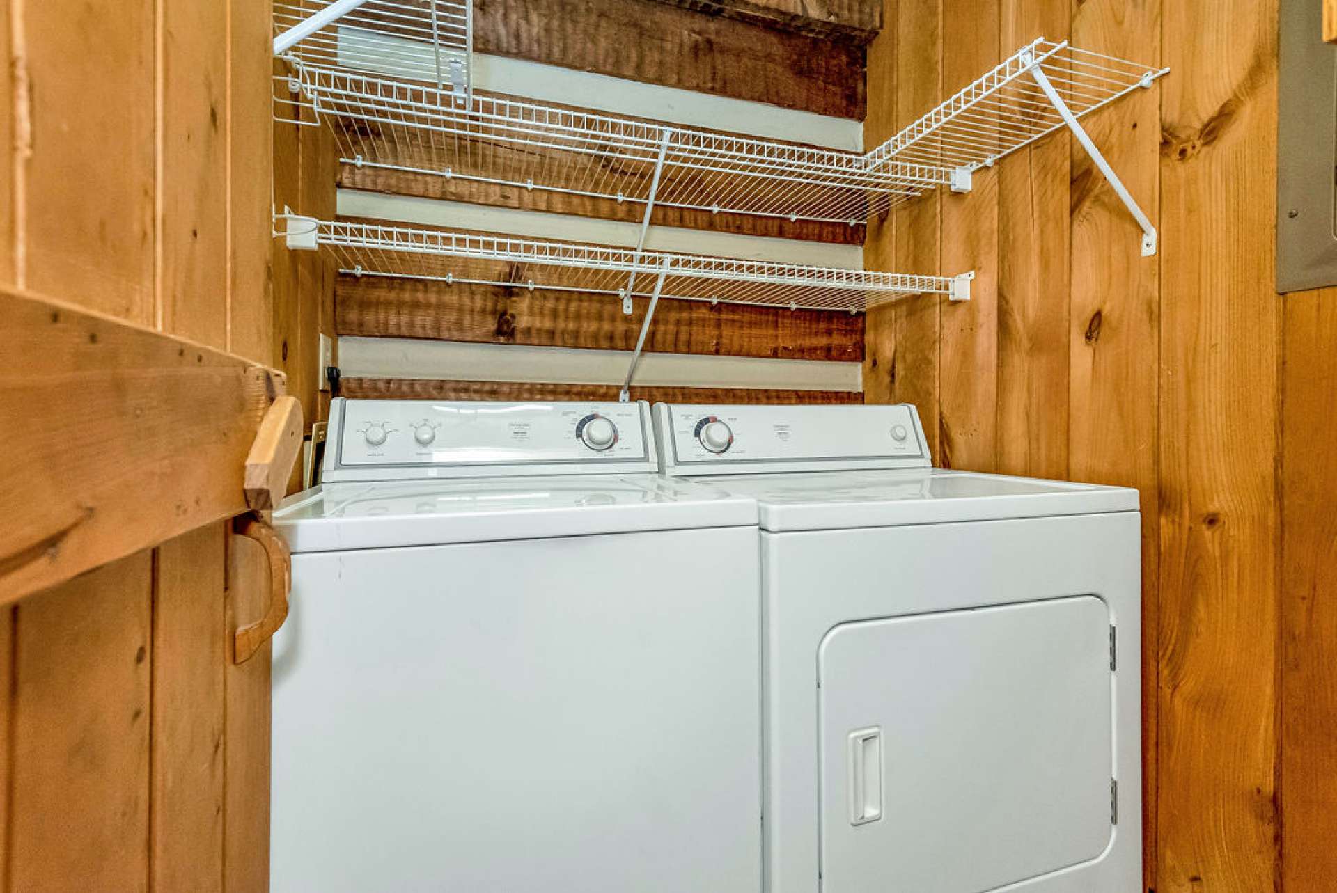 There's space for a full-size washer & dryer plus storage shelving with racks to hang your clothes straight out of the dryer.
