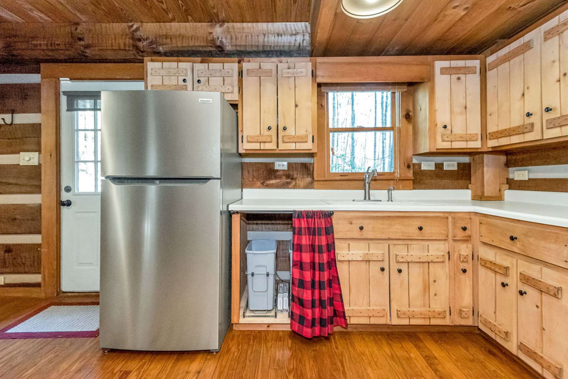 Trash cans are tucked away where a dishwasher could be added.