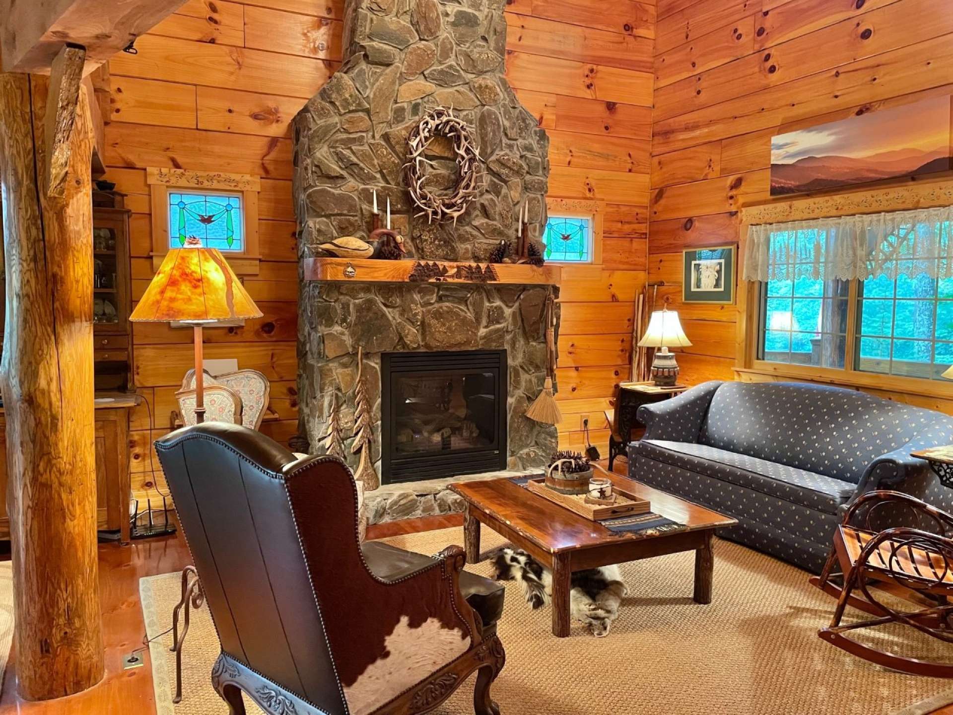 Experience Log Cabin living while enjoying the floor to ceiling stone wood burning fireplace, vaulted ceiling and wood floors.
