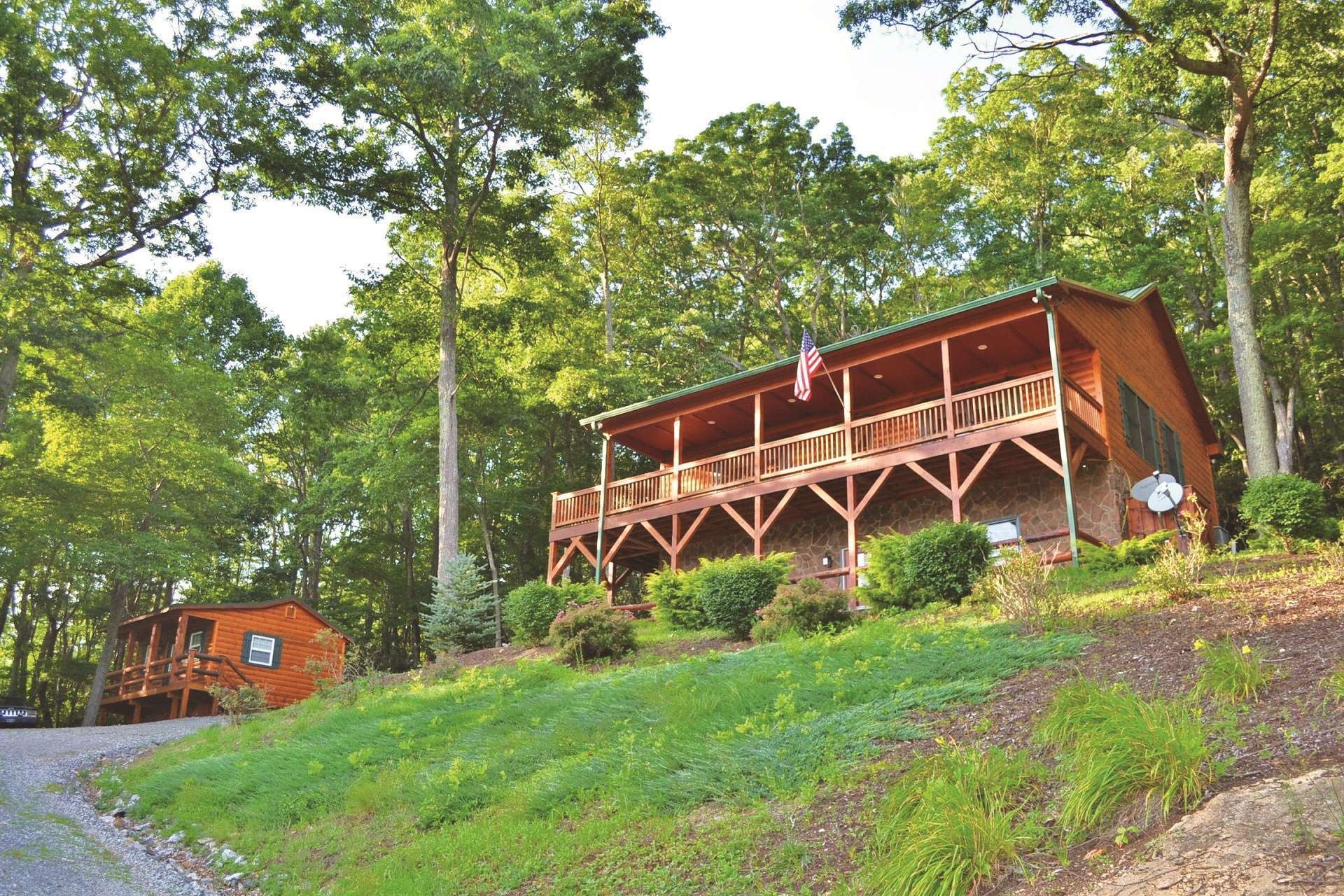 This custom cabin sits majestically on a knoll overlooking lush pastures with mountains beyond. The 5+ acre wooded setting provides privacy.