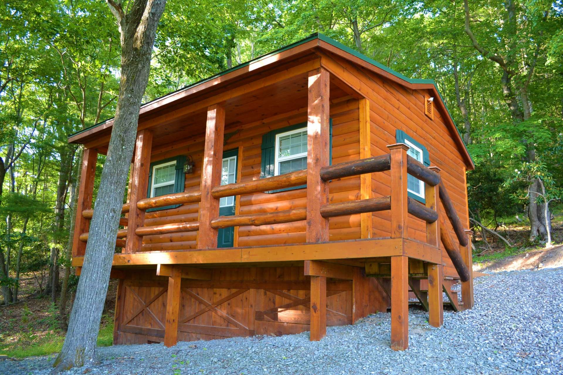 A small matching cabin/outbuilding offers an option for studio, storage, or finish out for guest cabin.
