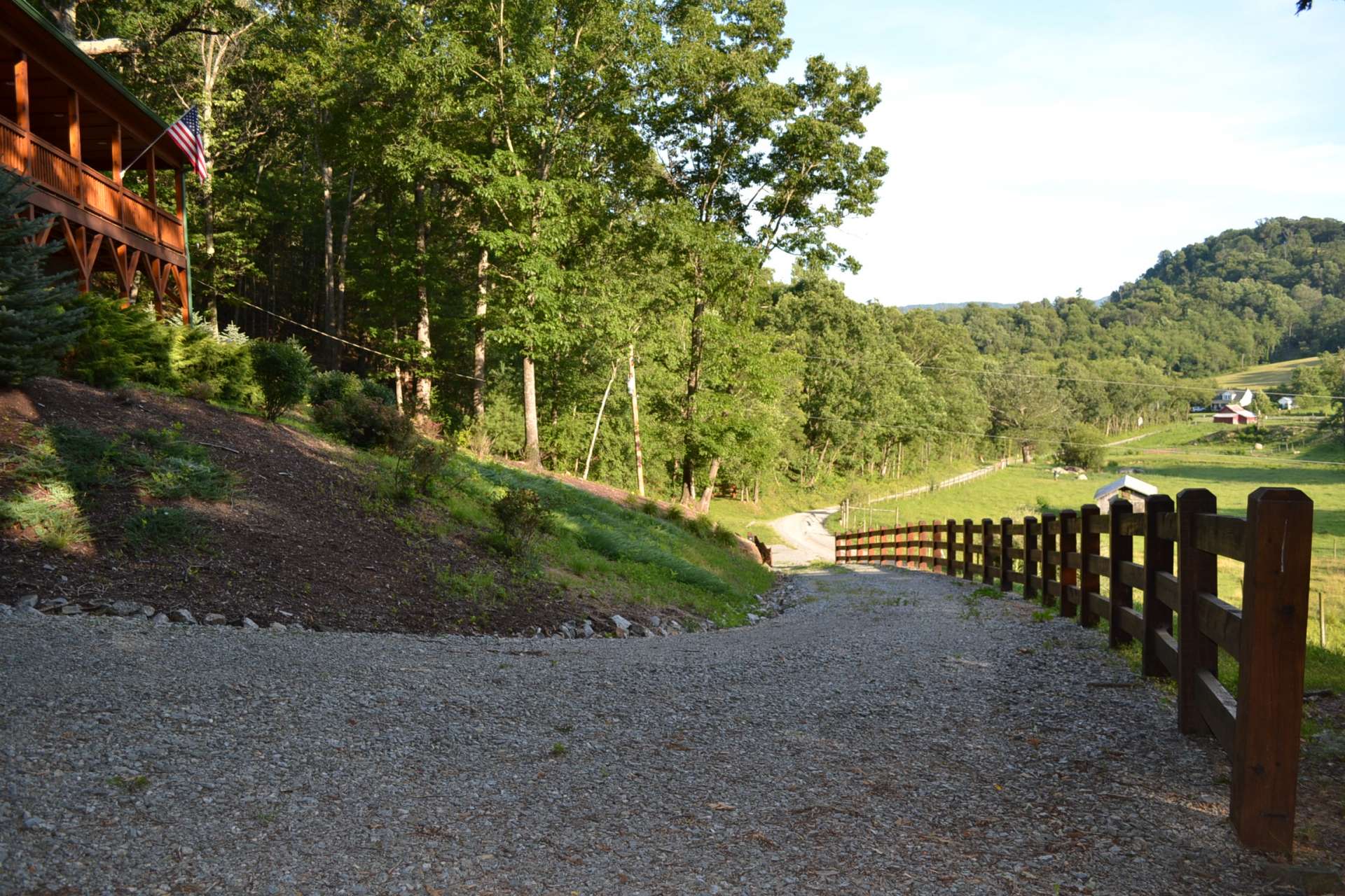 A gated gravel drive with Western Red Cedar post and rail fence brings you home.