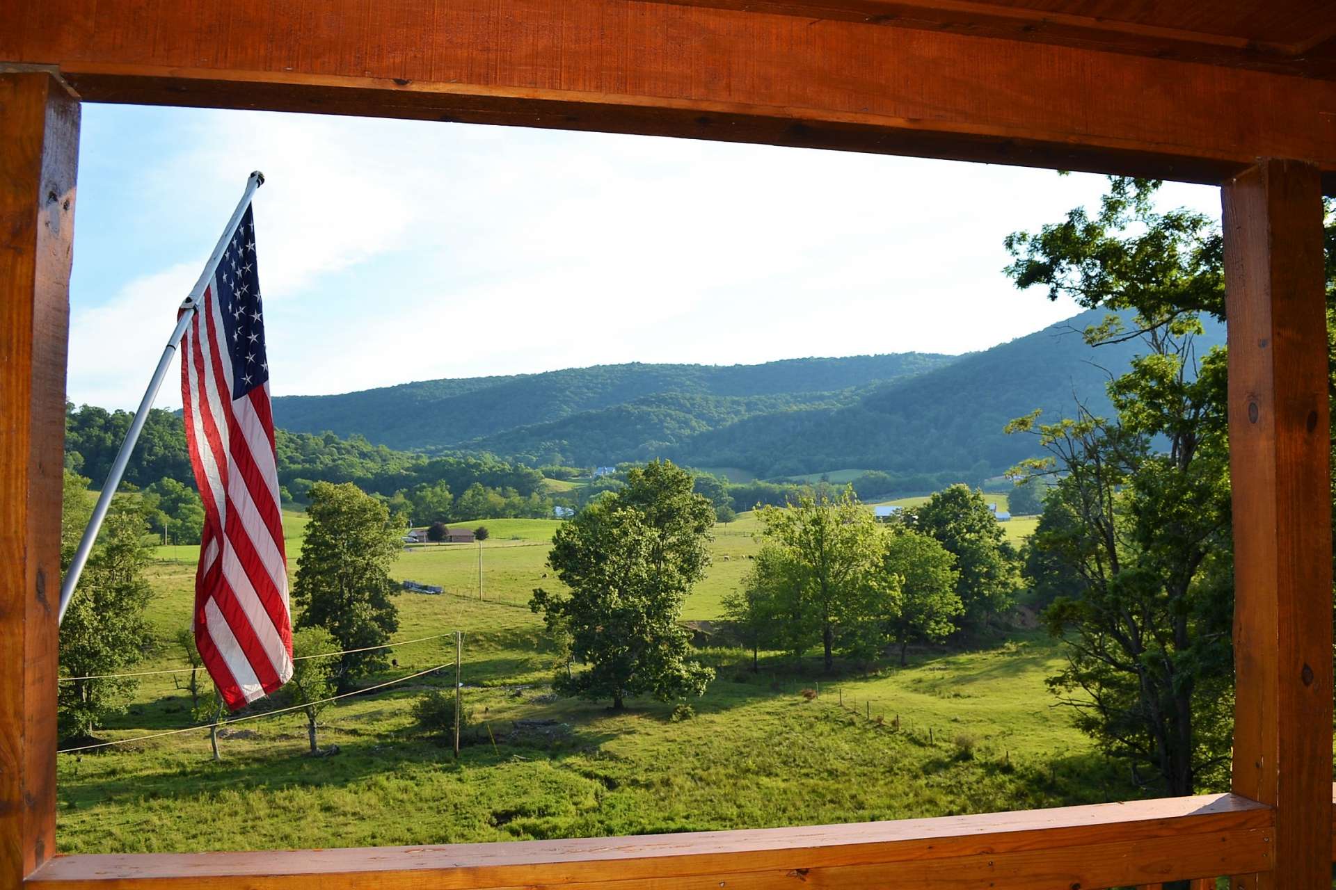 This is view from front covered porch. You will love how the porch frames the views of the quiet countryside as well as watching the neighbor's farm animals.