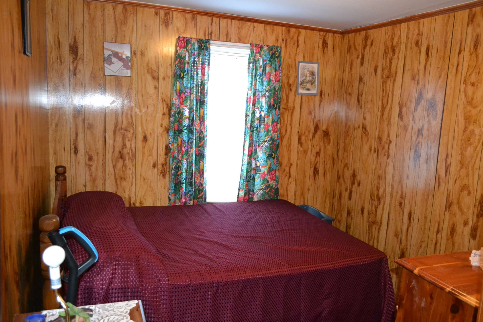 This main level bedroom is cozy with wood floor.