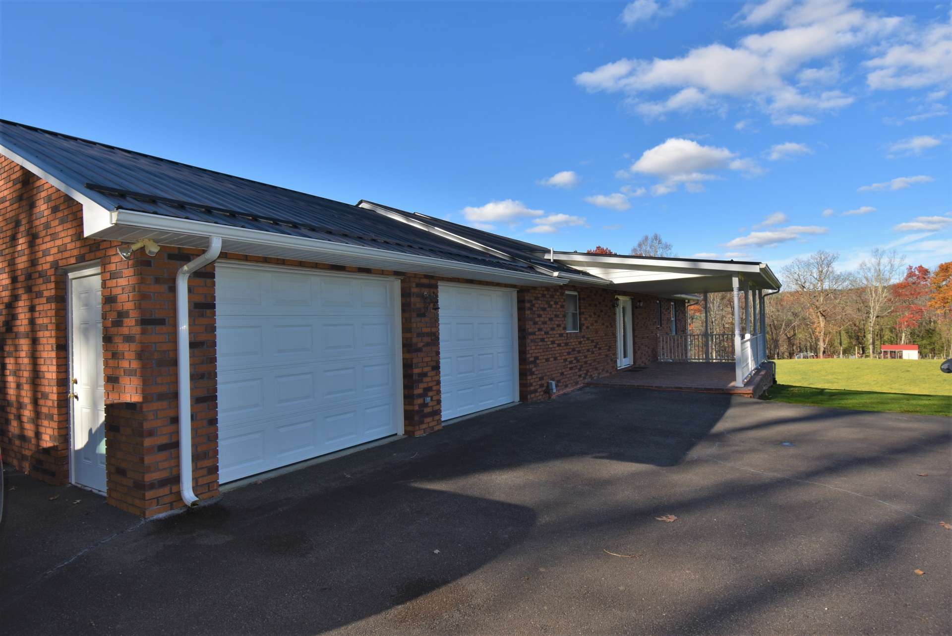 A paved drive winds around to the back of the house and a 2-car garage providing easy access from the outside to the kitchen and dining area.