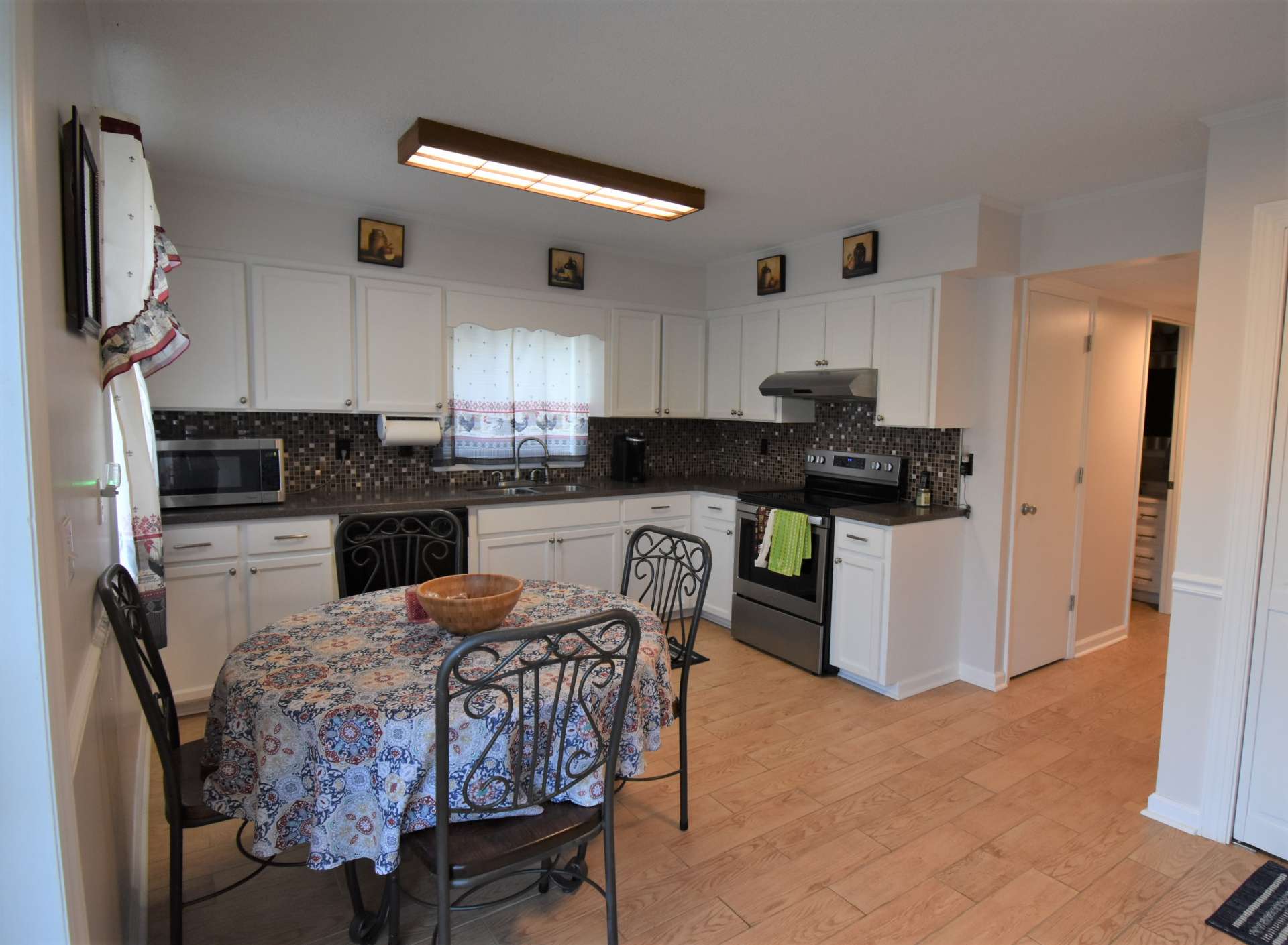 What a charming kitchen in the lower level. Everything you need plus character.