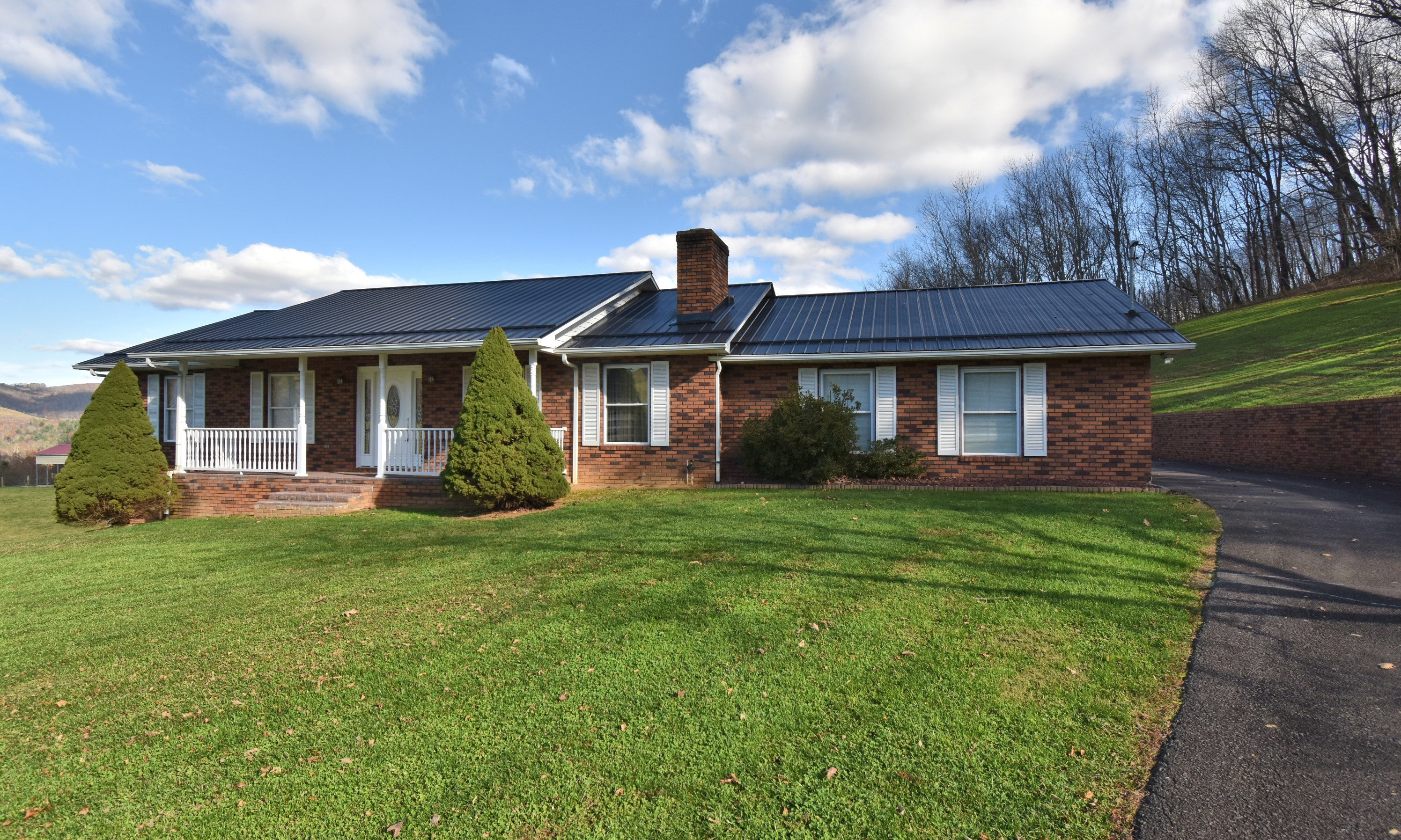 Designed with clean, classic, contemporary lines this extraordinary ranch style home rests among lovingly kept grounds with mountain & farmland views from both the covered front porch & back porch. This spacious home features gracious living spaces on both the main and lower level offering the perfect space for extended family or rental income.