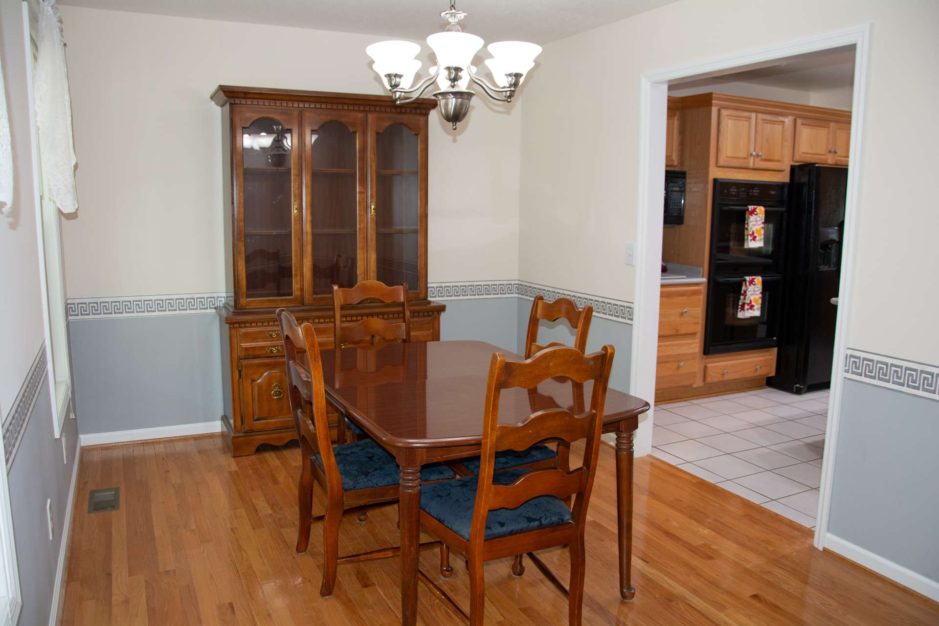 Dining area is conveniently located between the kitchen and living room.  Plenty of room for table, chairs and hutch.