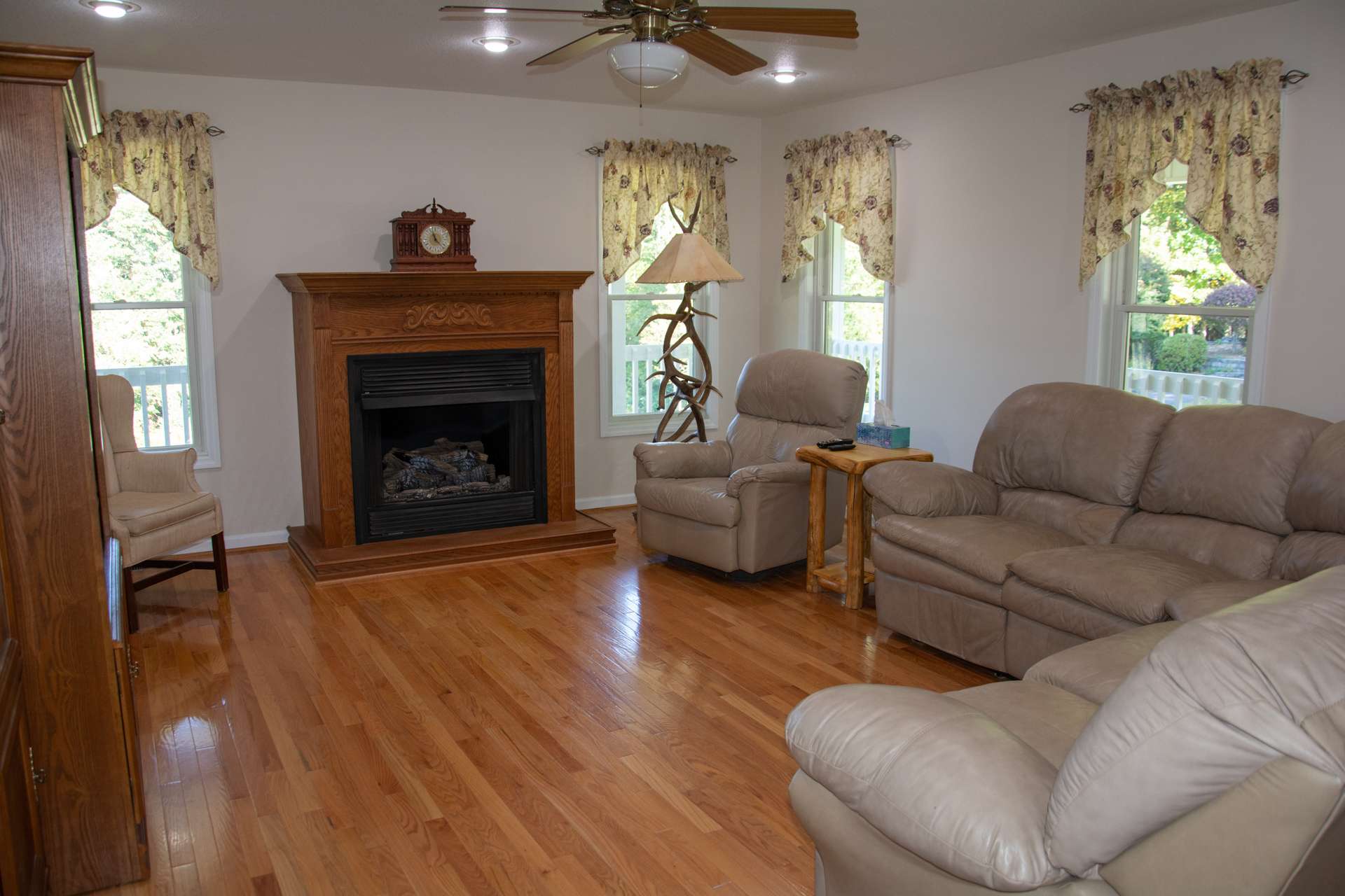 Spacious living room features gleaming oak flooring, fireplace with gas logs and lots of windows making it nice & bright.