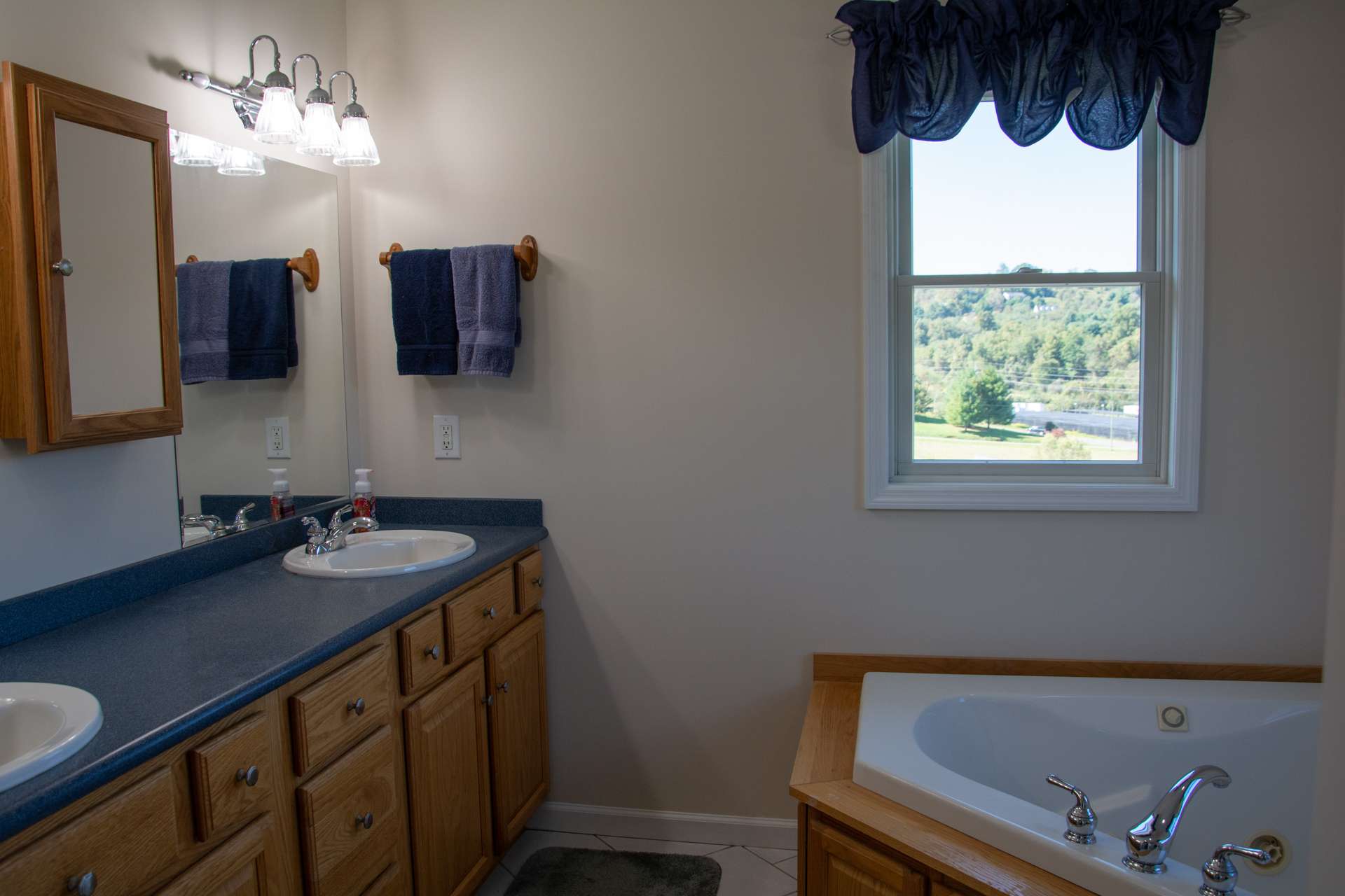 Master bath offers double vanity with lots of storage and counter space, a large whirlpool tub and separate shower.