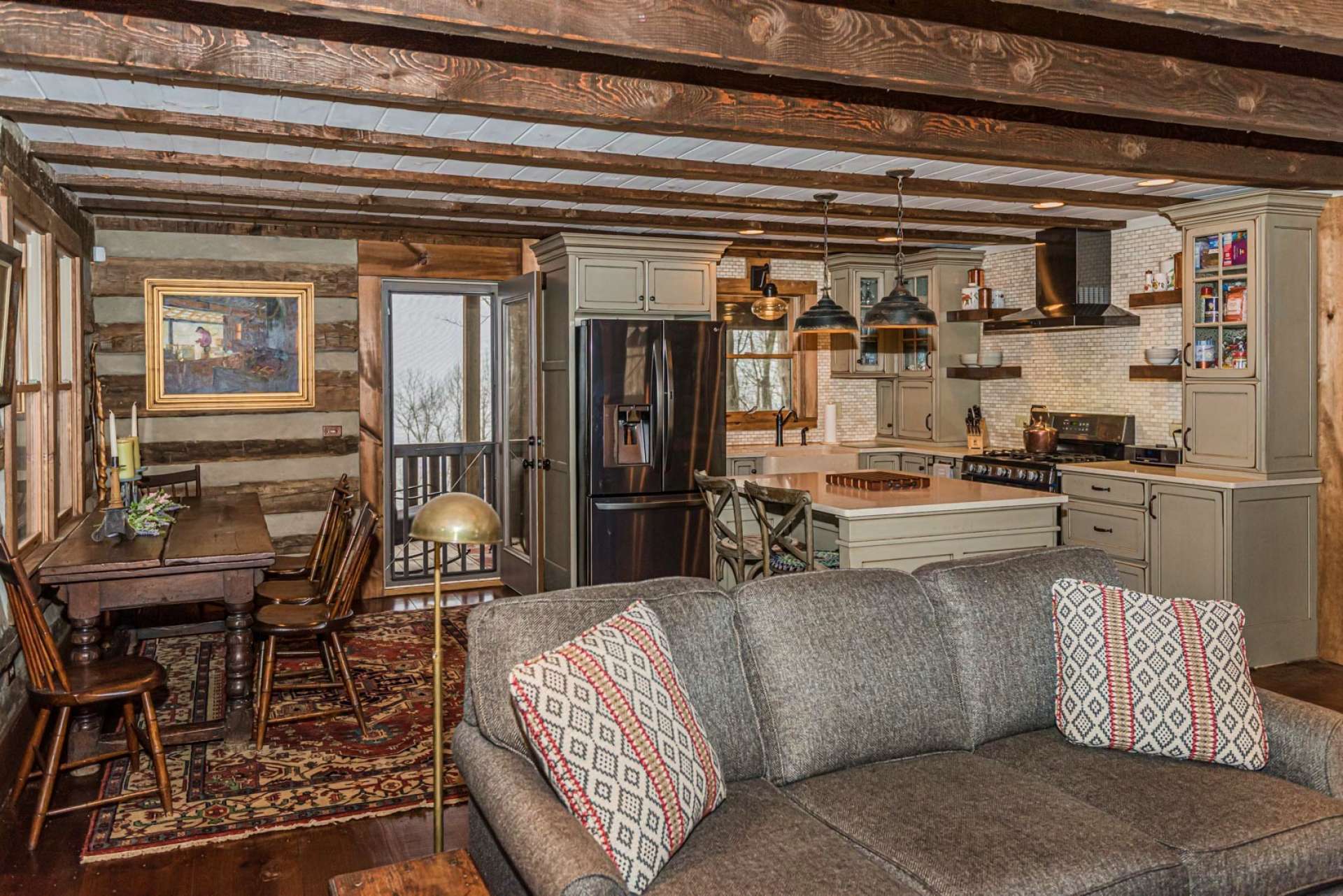 The beamed ceiling adds to the rustic touches of the cabin while the kitchen brings in the modern conveniences and upscale details.