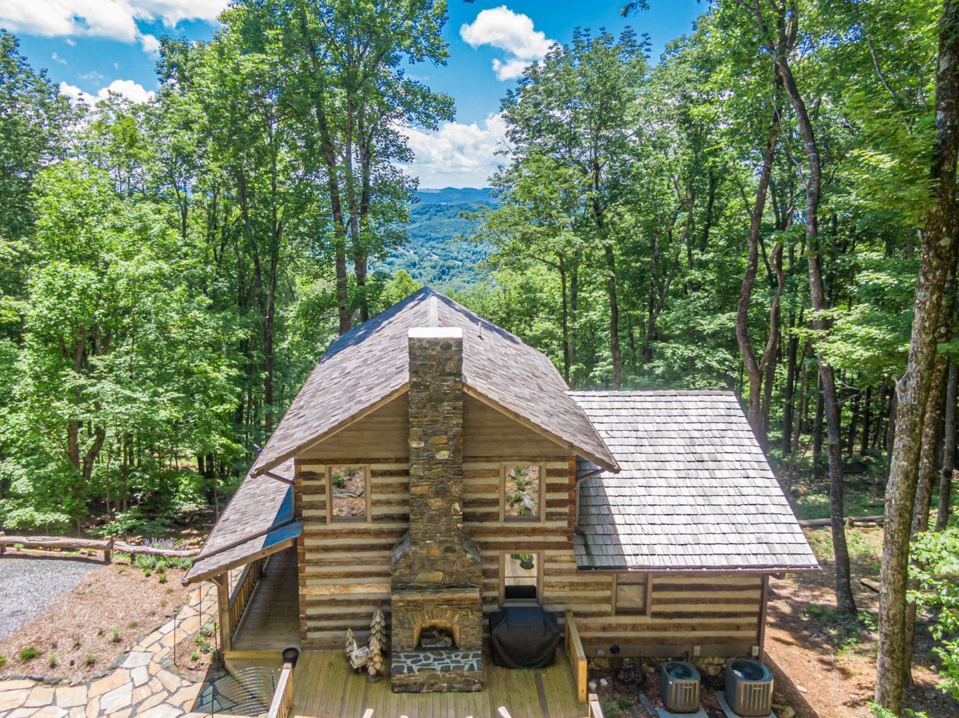 This photo shows the back deck featuring third stone fireplace and perfect for family get togethers, toasting marshmallows by the fire and planning the next day's activities. Will it be floating down the New River or hiking the Blue Ridge?