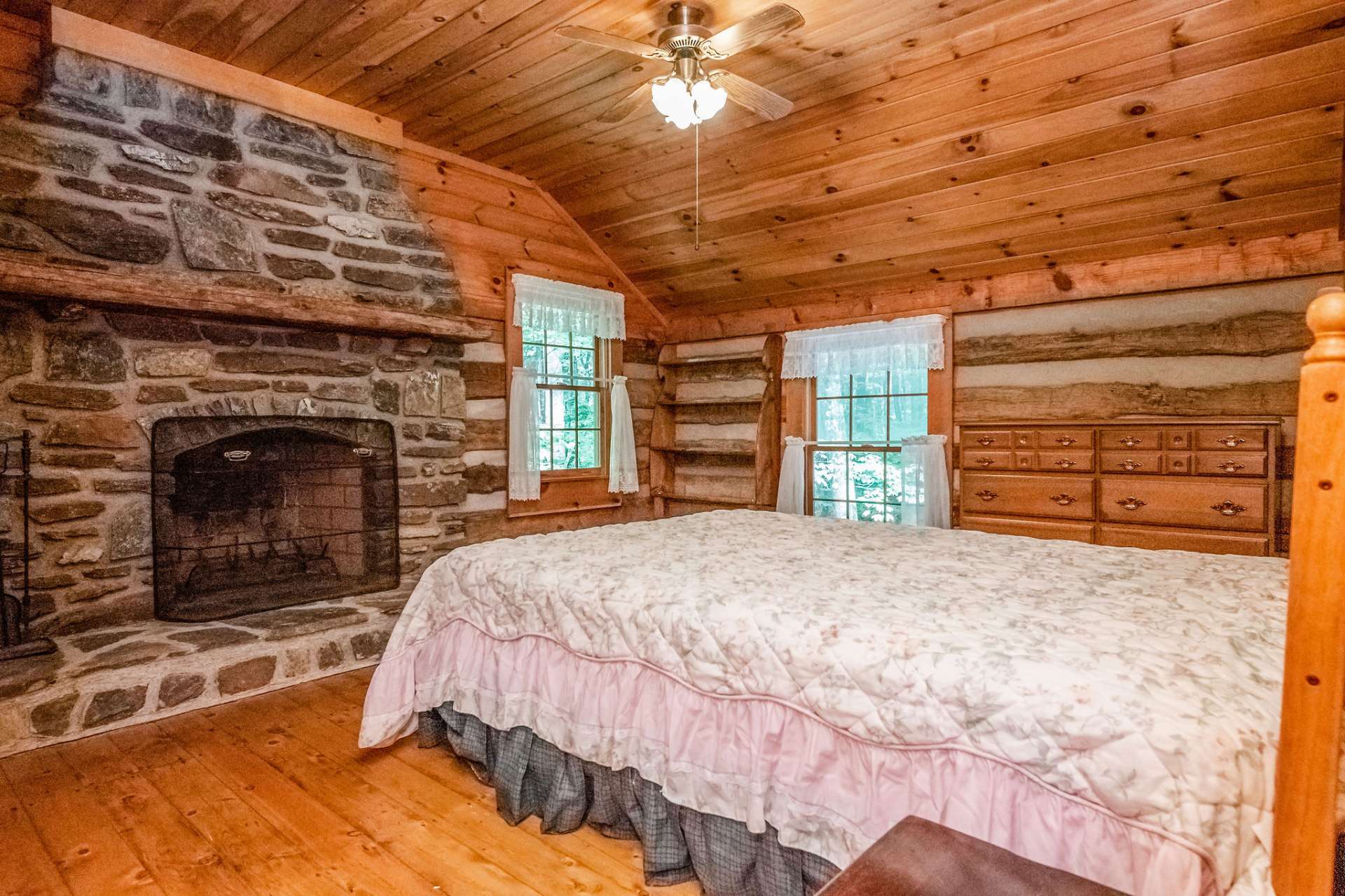 Upper level bedroom will excite your guests with this romantic fireplace.