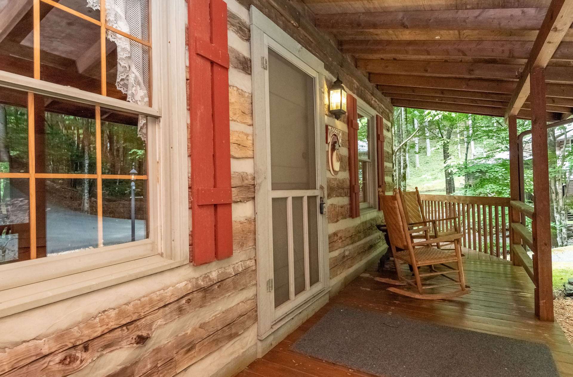 Entry porch is covered and offers an outdoor area to rock away your cares with the calming sounds of the creek.