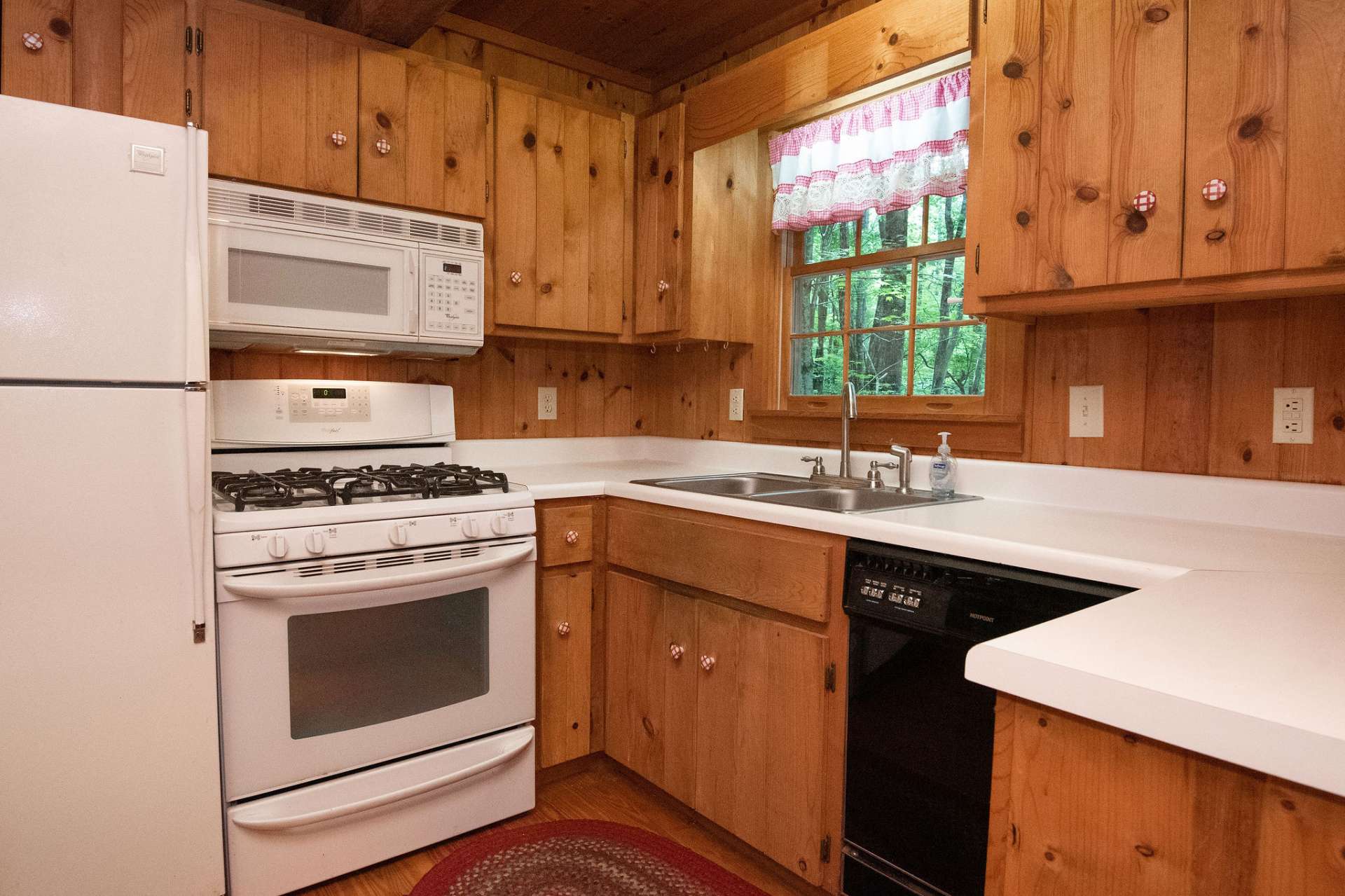 There's nothing missing in this kitchen equipped with gas range, built-in hood microwave and dishwasher.