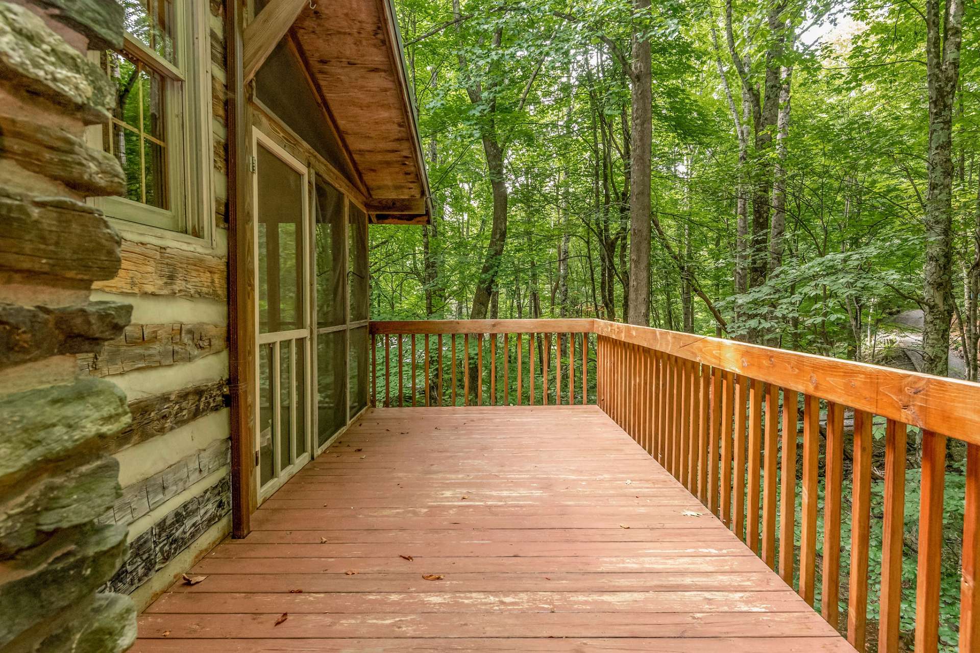 Side deck overlooks the creek and is a perfect location to set up an outdoor living area to entertain family and friends.