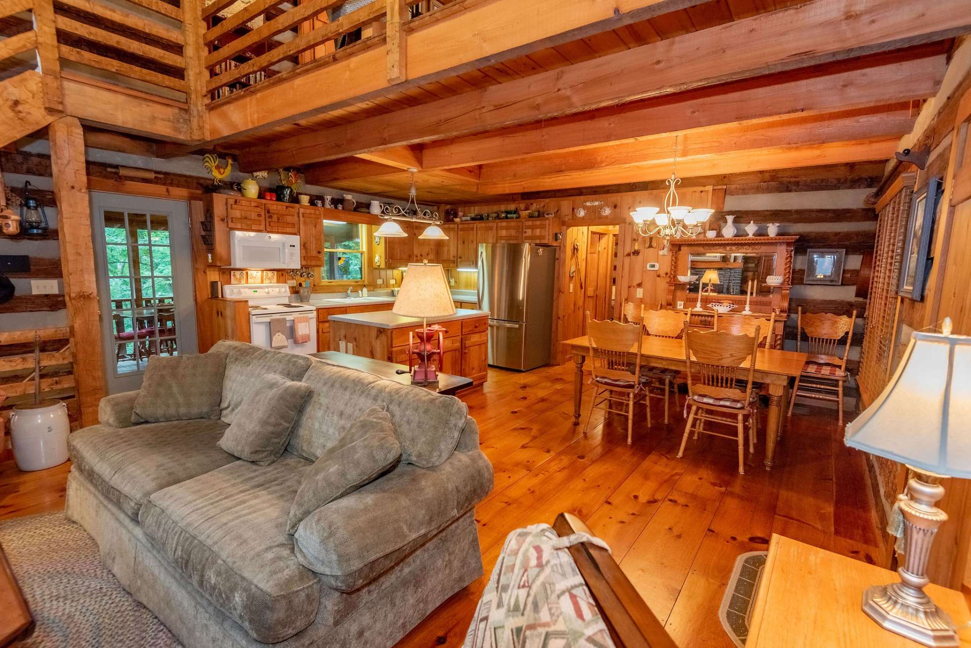 The interior features wide-plank wood flooring throughout the cabin.
