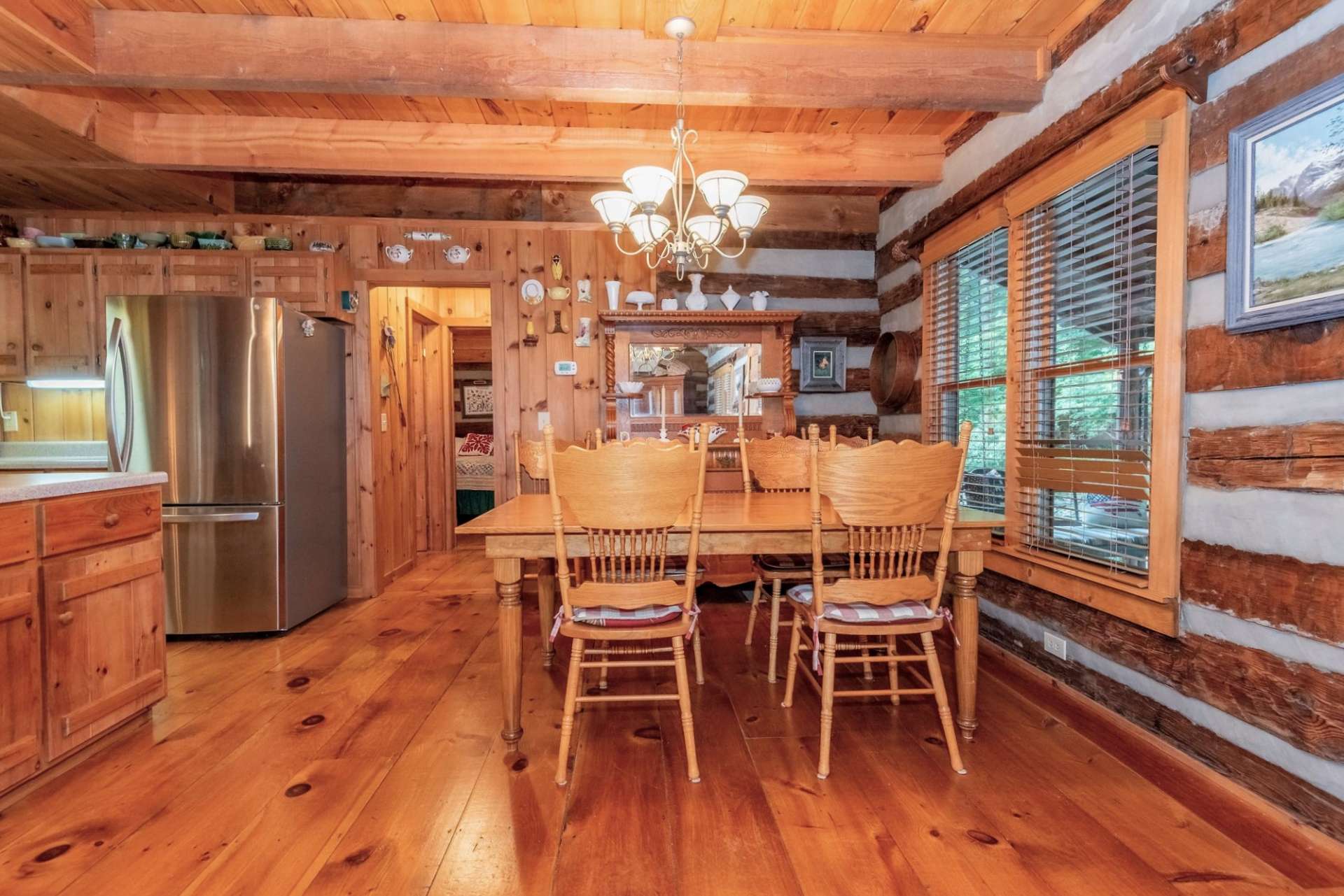 View of dining area to a hallway with primary bath on one side and convenient main floor laundry area on the right.