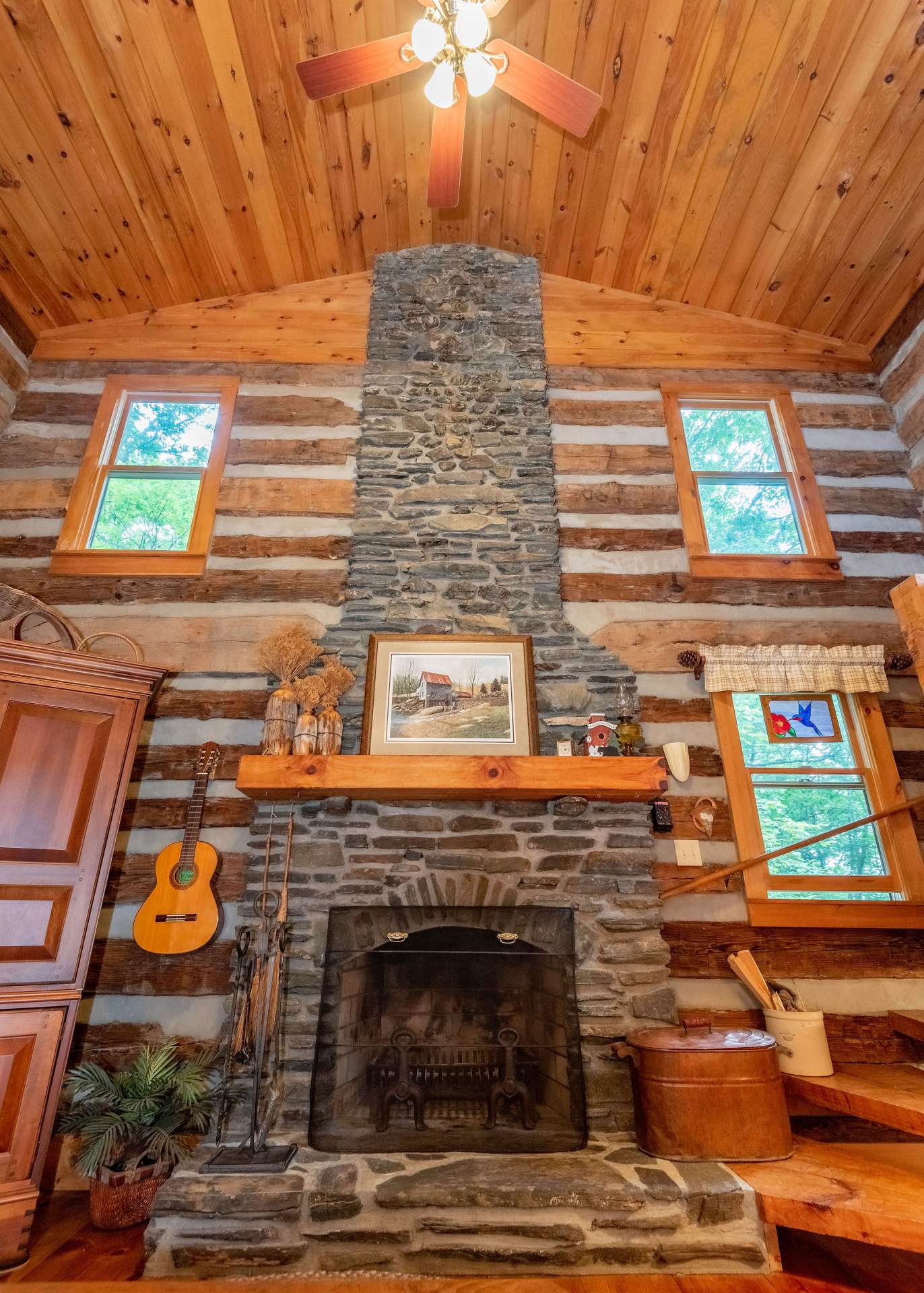 A wood burning native stone fireplace highlights the cathedral ceiling.