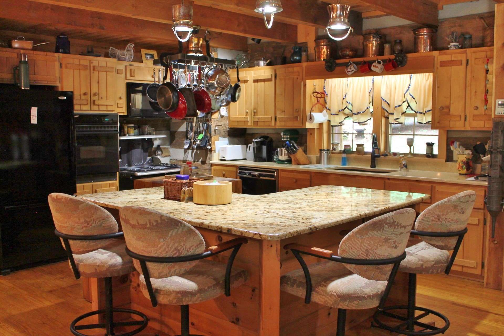 The kitchen is spacious enough to accommodate more than one chef and abundant storage in the custom cabinetry. Notice the antique butcher block - perfect for that extra meal preparation area.