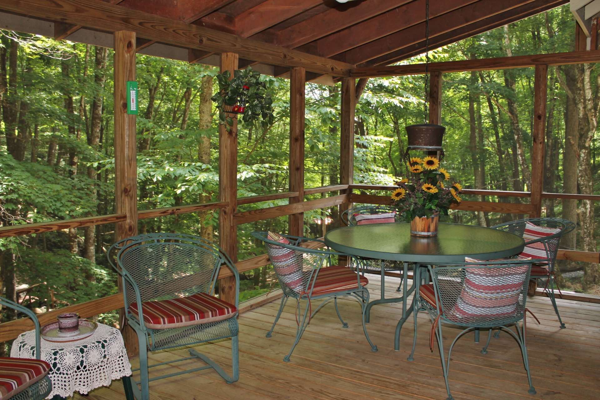 Or, take the meal outside to this covered and screened porch where you can enjoy fresh mountain air along with the sounds of Nature and the rushing creek.