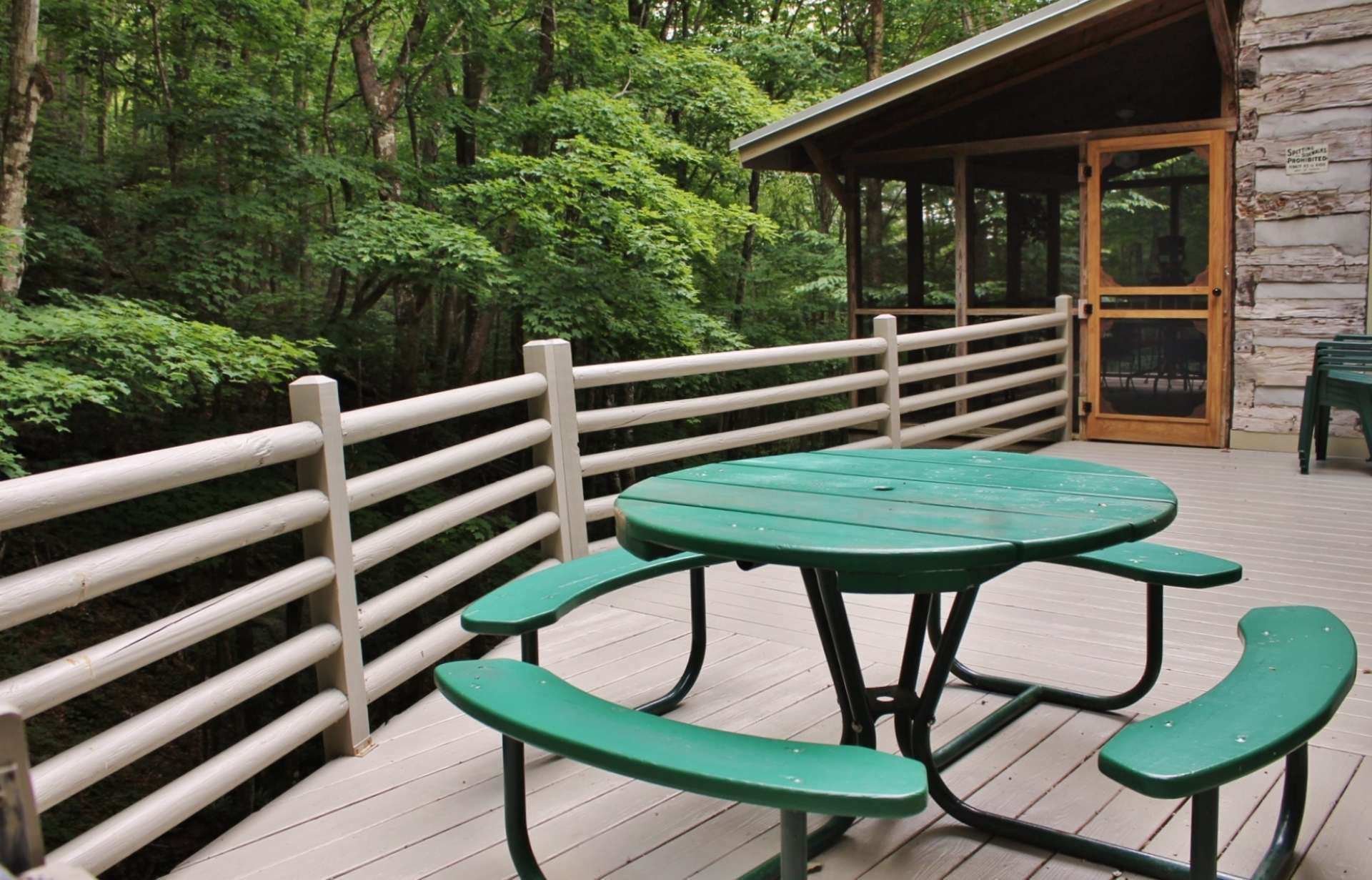 The open deck is ideal for summer barbecues and has stairs leading down to creek.