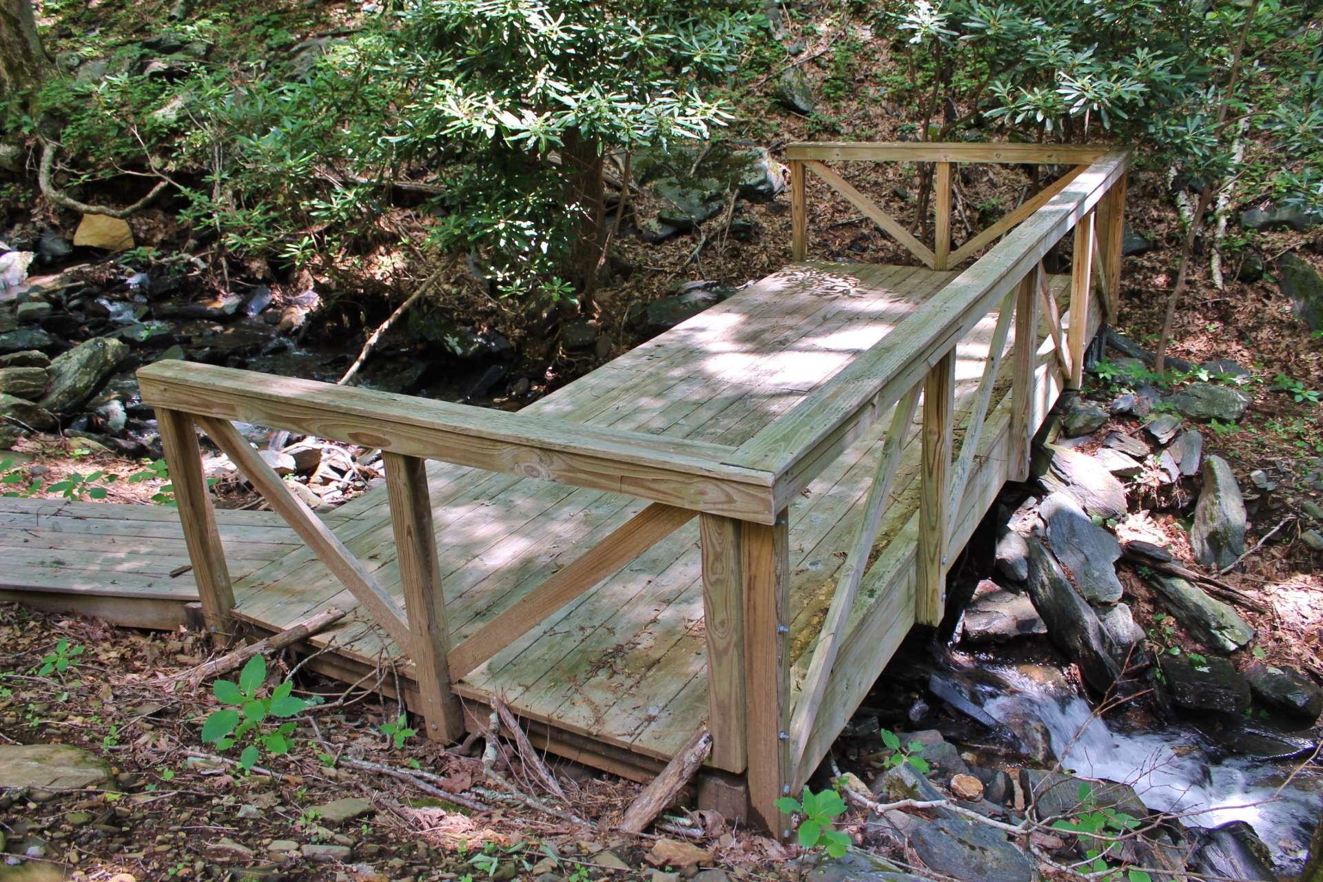 A unique platform bridge takes you over the rushing waters. This outdoor area is an ideal spot to entertain family and friends.