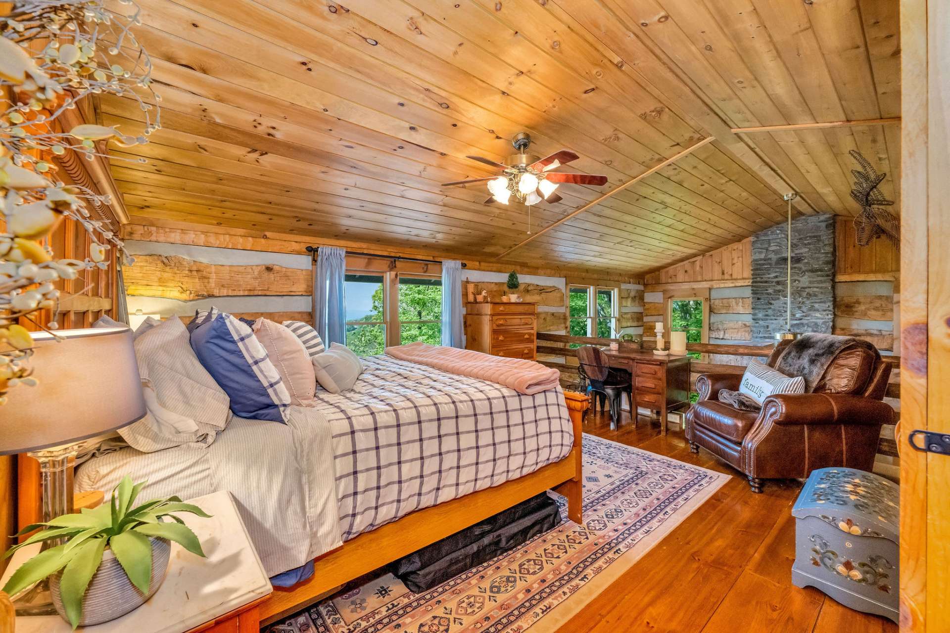 The first guest bedroom is an open loft overlooking the majestic 2 story fireplace.