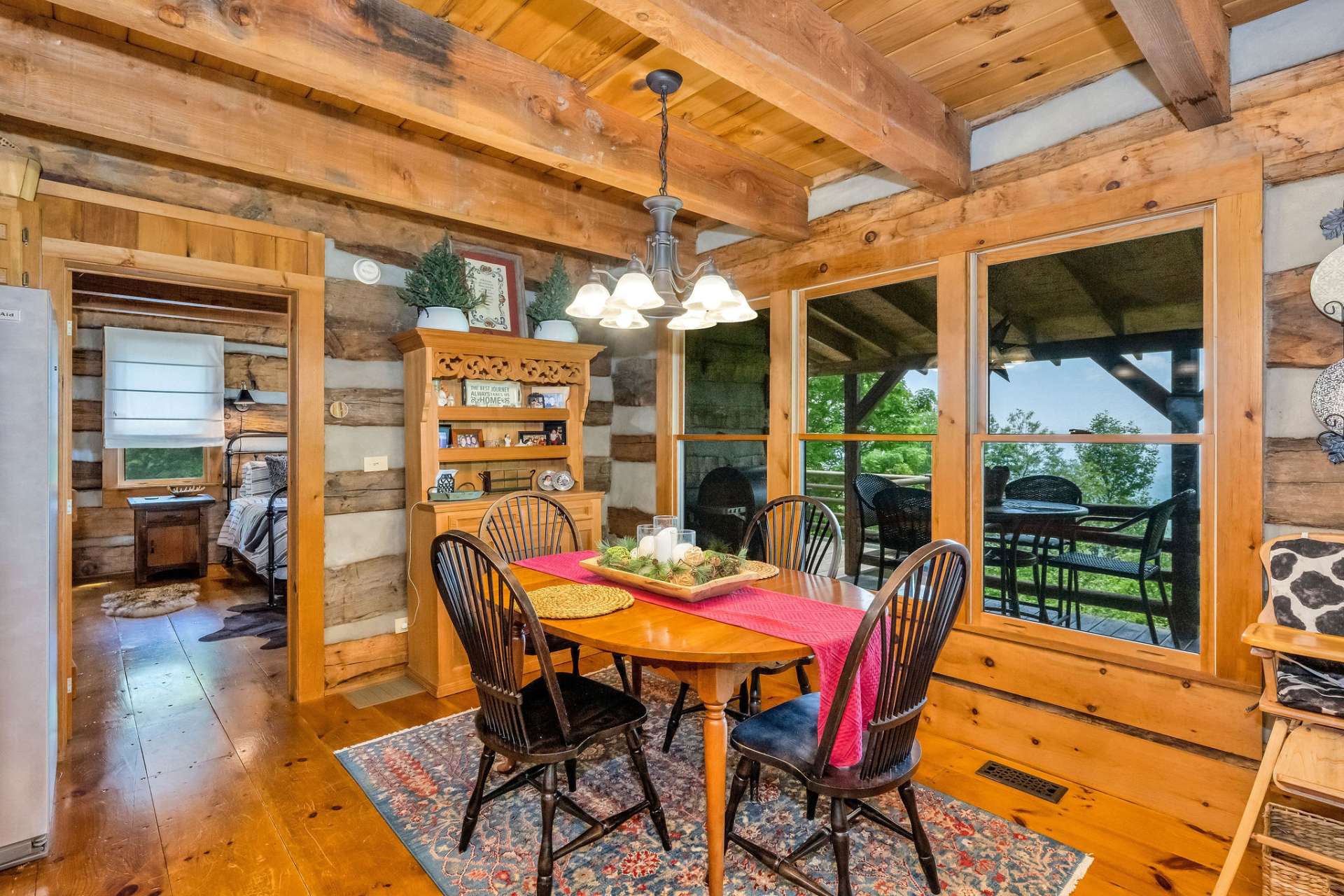 This dining area creates a unique dining experience with a wall of windows framing nature's beauty.