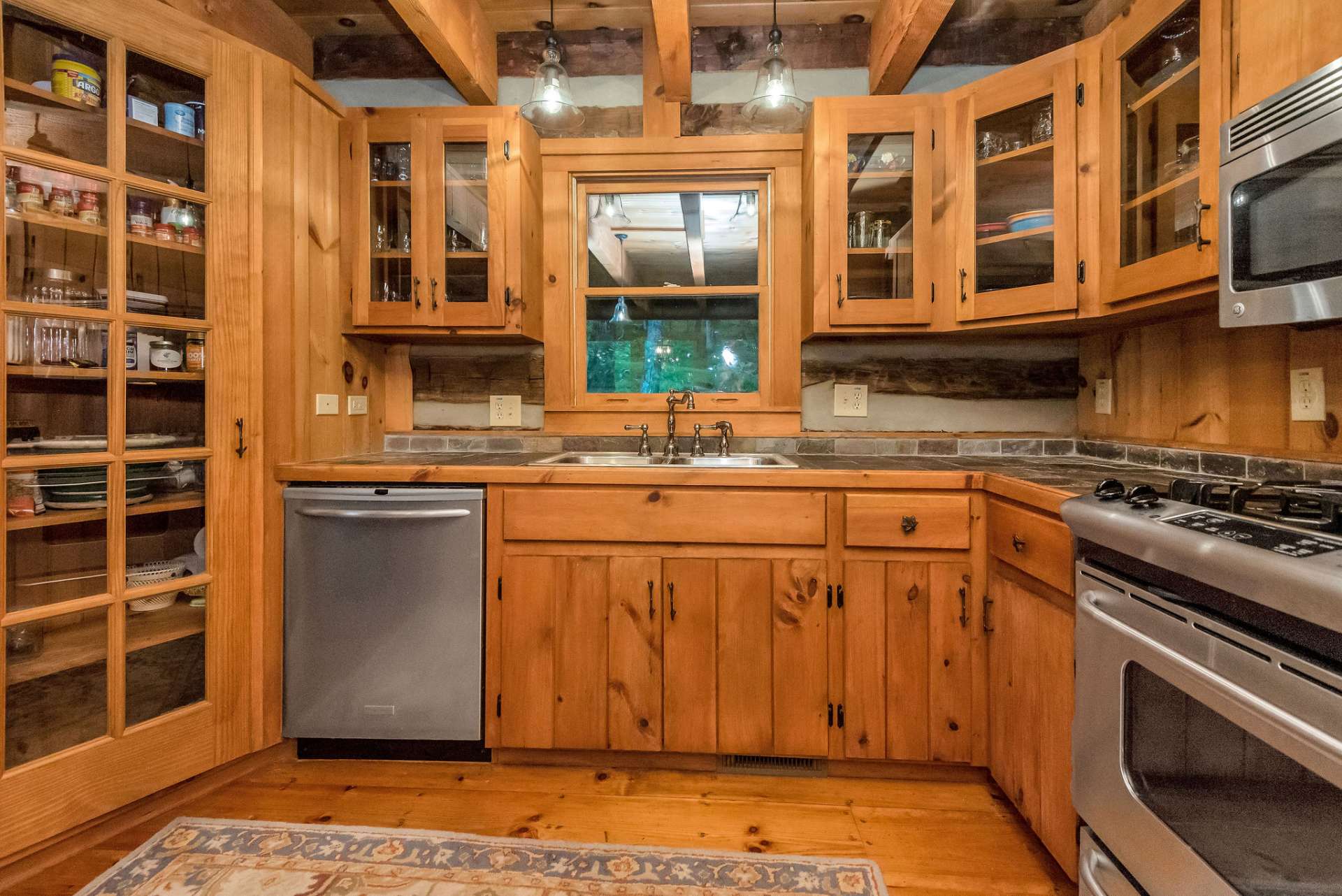 The convenient glass door pantry adds to the modern rustic charm of this cabin.