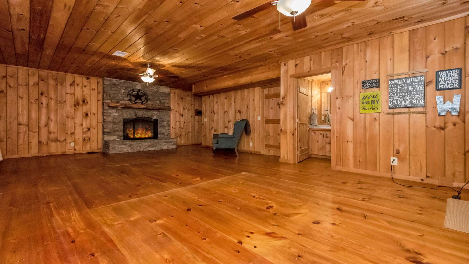The lower level family room features an additional stone fireplace to keep the lodge vibe flowing.