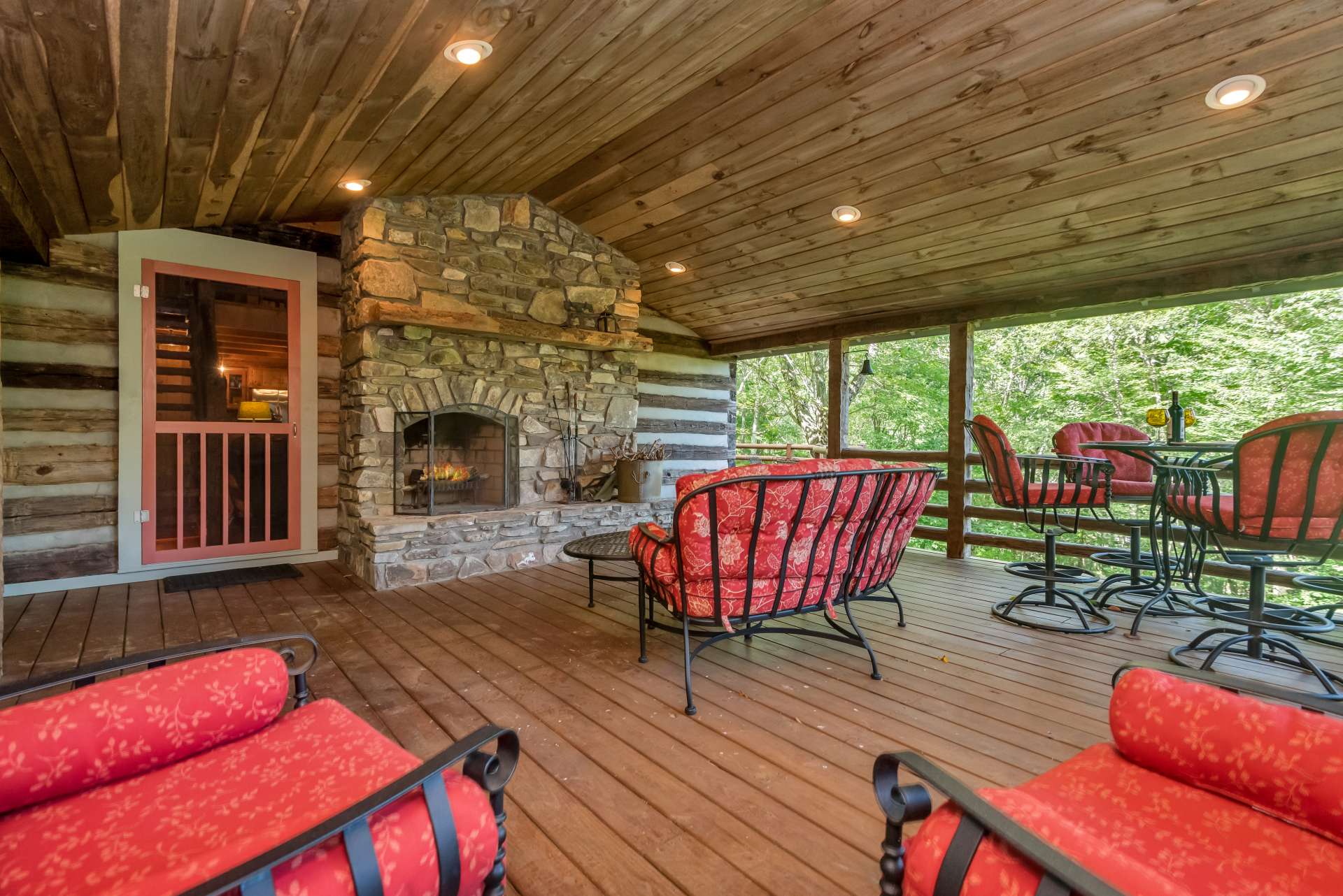 Enjoy evening drinks and conversations around the outdoor stone fireplace.
