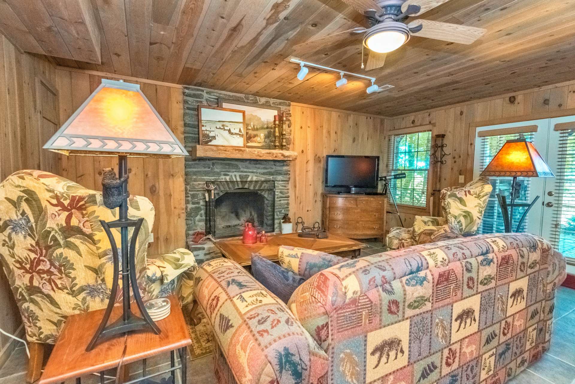 Family room on lower level offers a second stone wood burning fireplace.