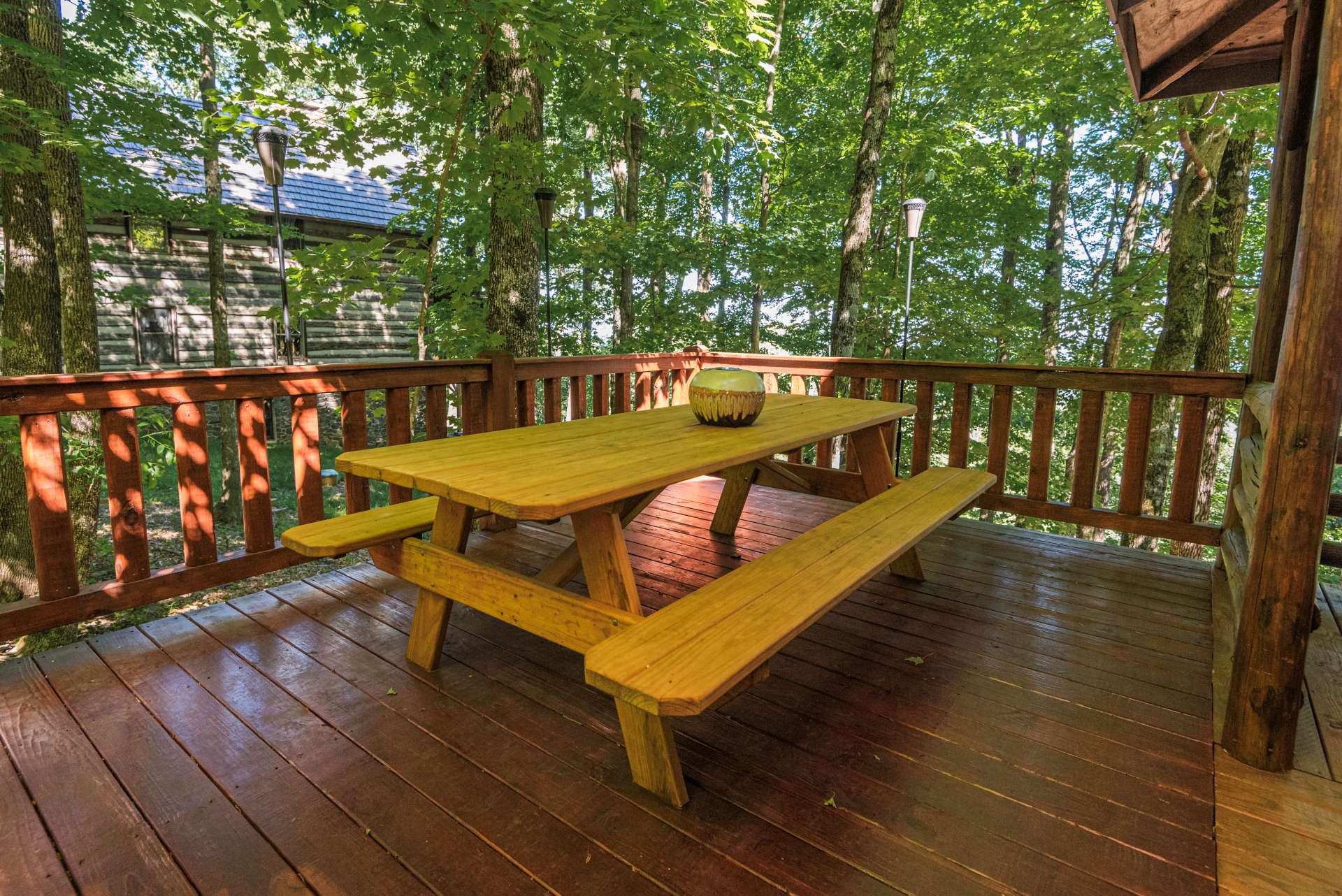 Large upper wrap around deck offers an alcove with dining area.