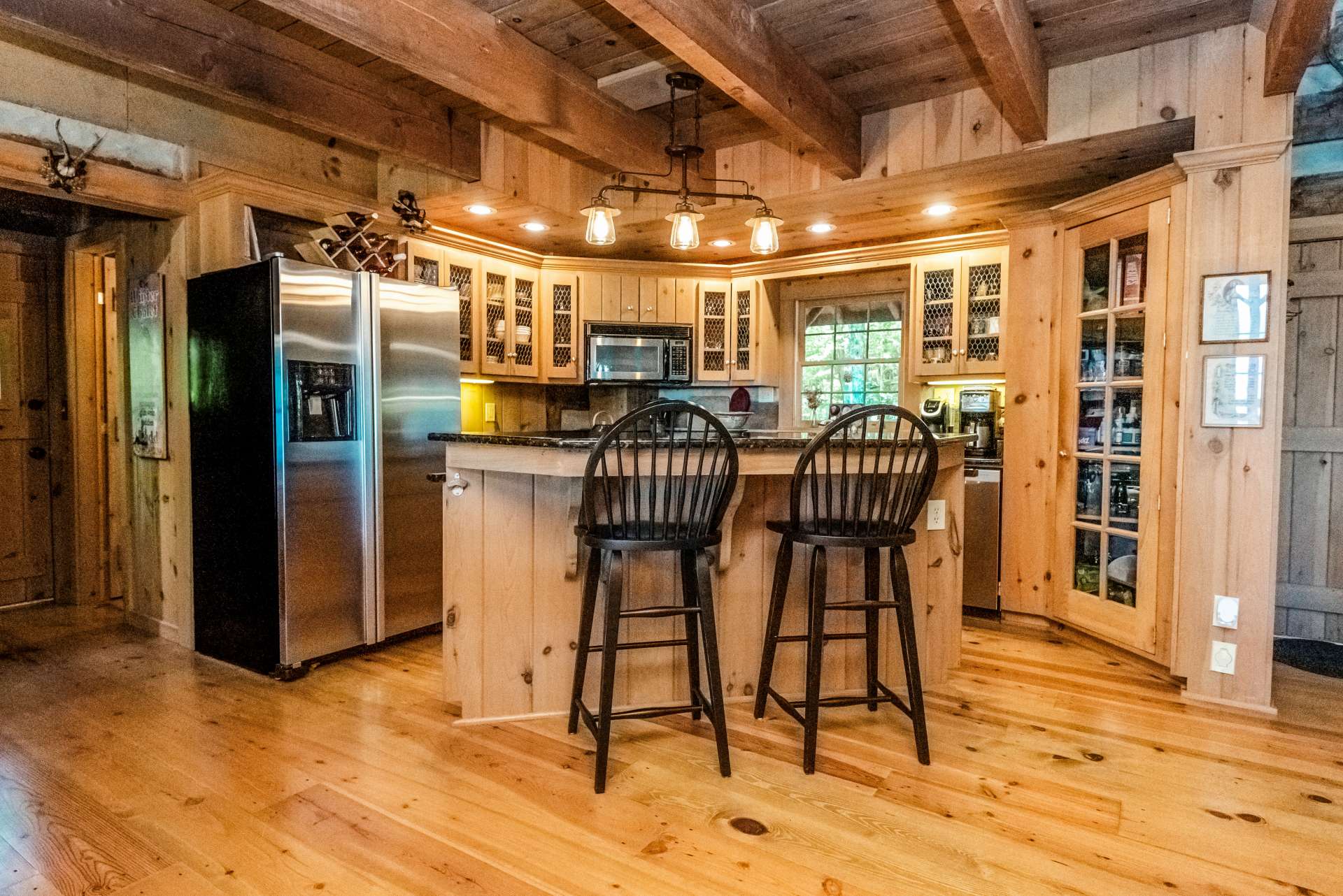 Kitchen offers abundant custom designed cabinets, gas range, and granite counter tops.