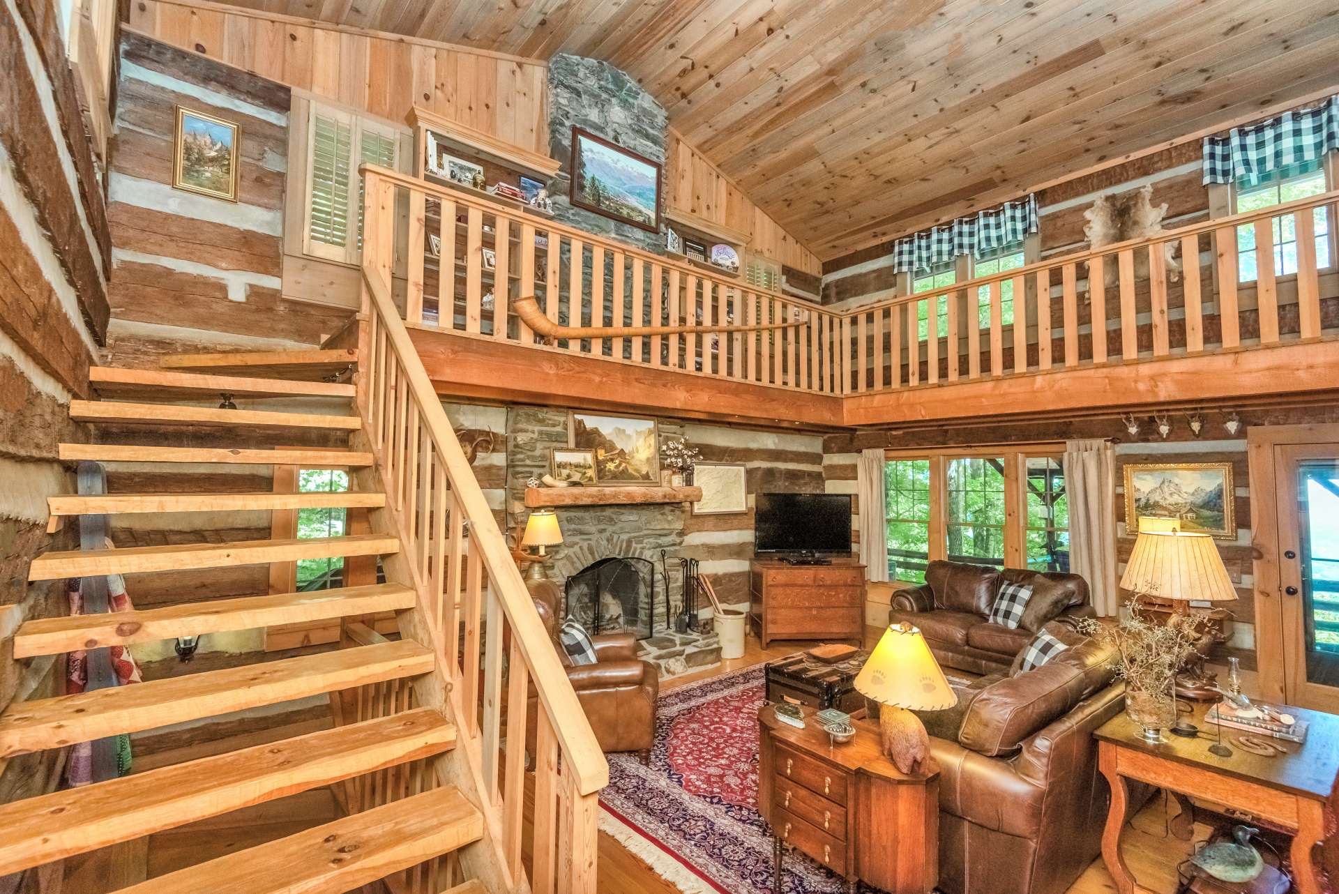 Hand hewn staircase and unique catwalk lead to the master suite.