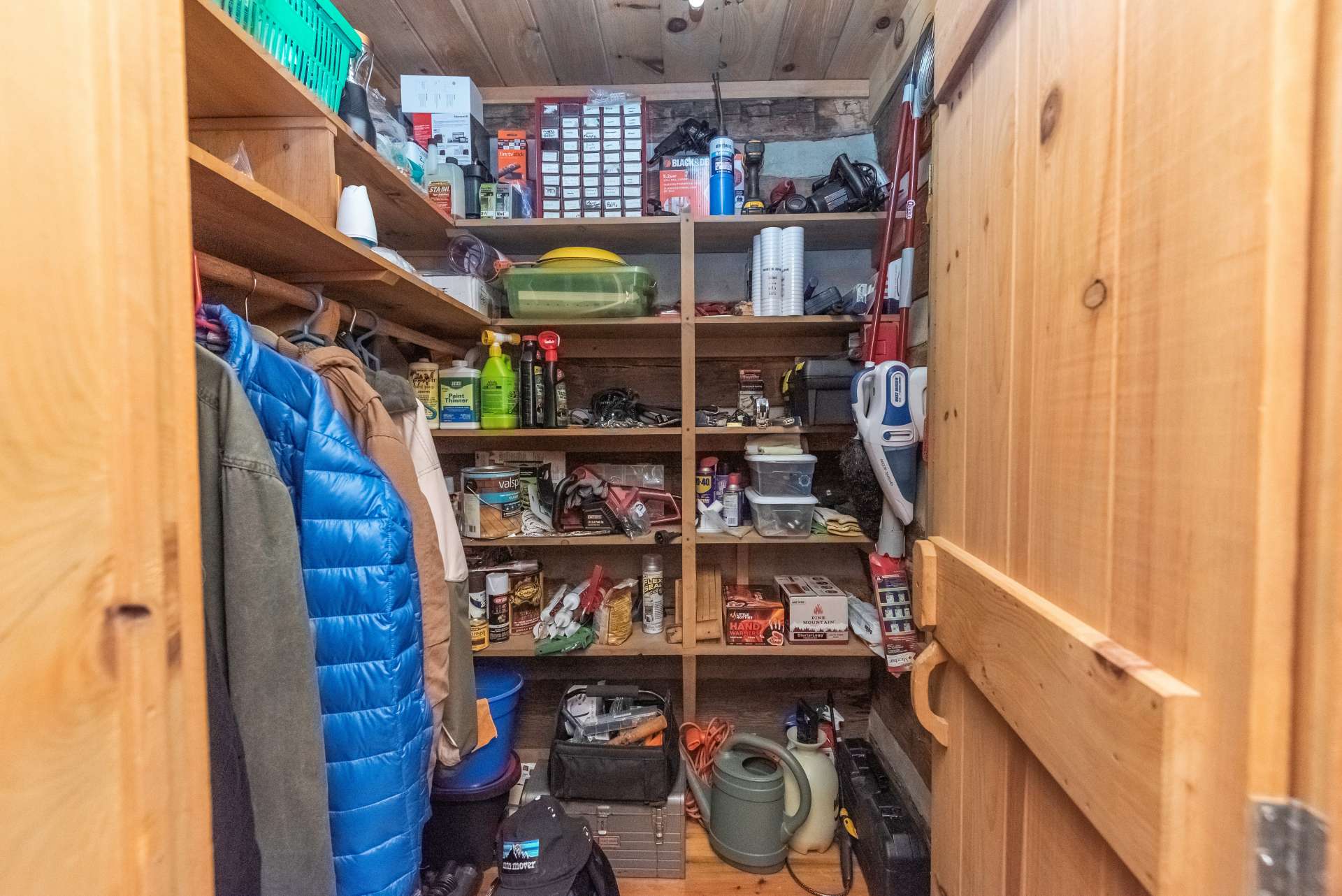 This large storage area adjacent to the kitchen is the perfect space for a pantry and can also serve as a coat closet.