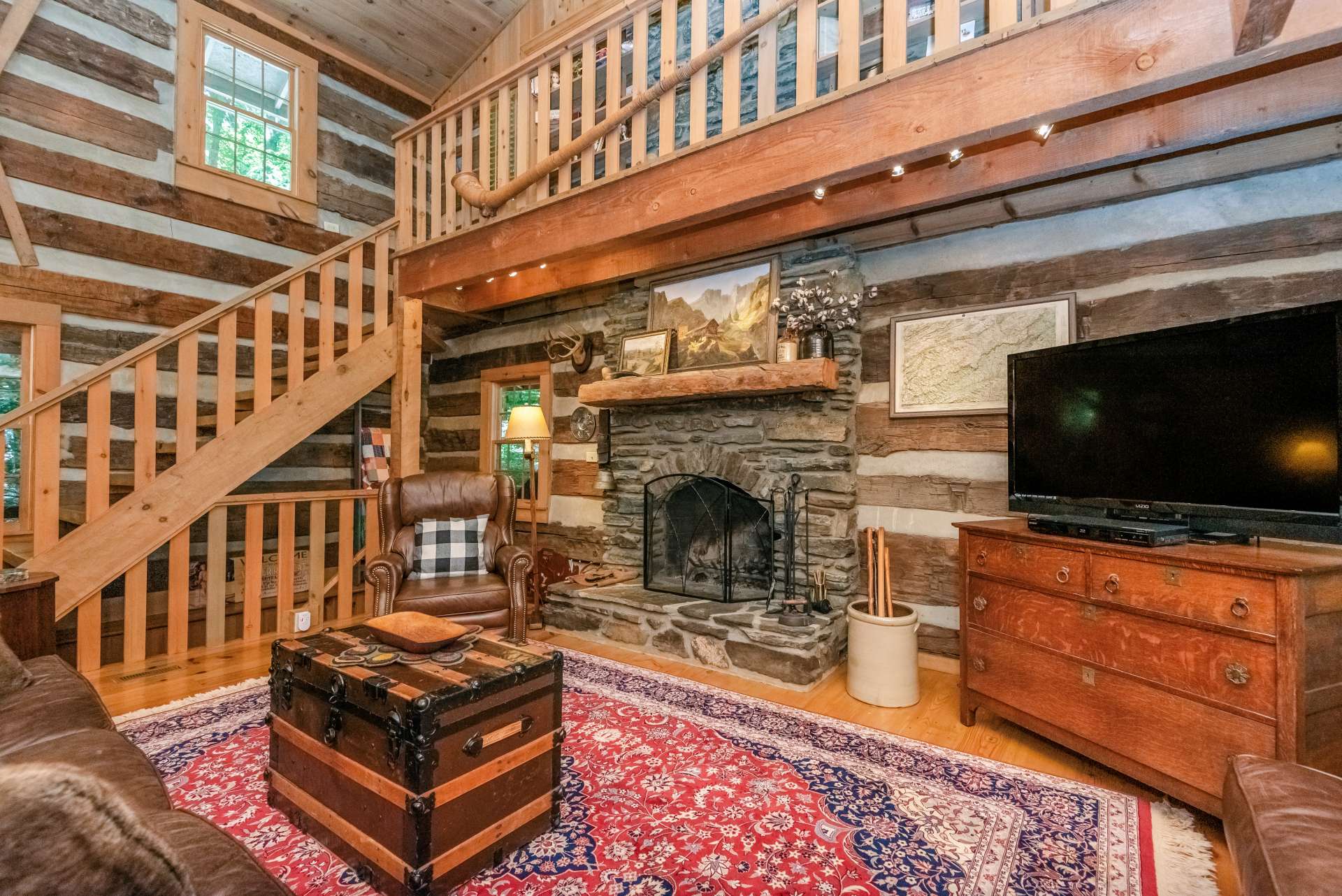 Main level living area offers a native stone fireplace to cozy up to loved ones.