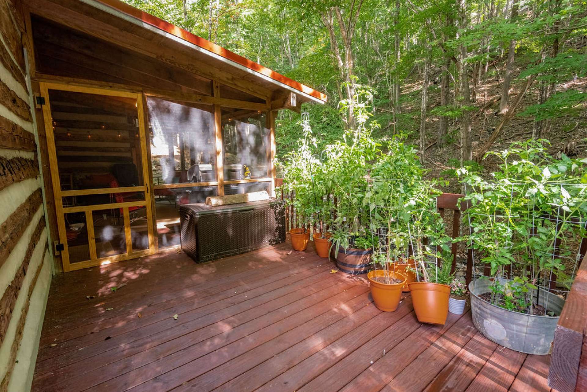 Screened in porch off of the kitchen offers an additional dining area during the warmer months.