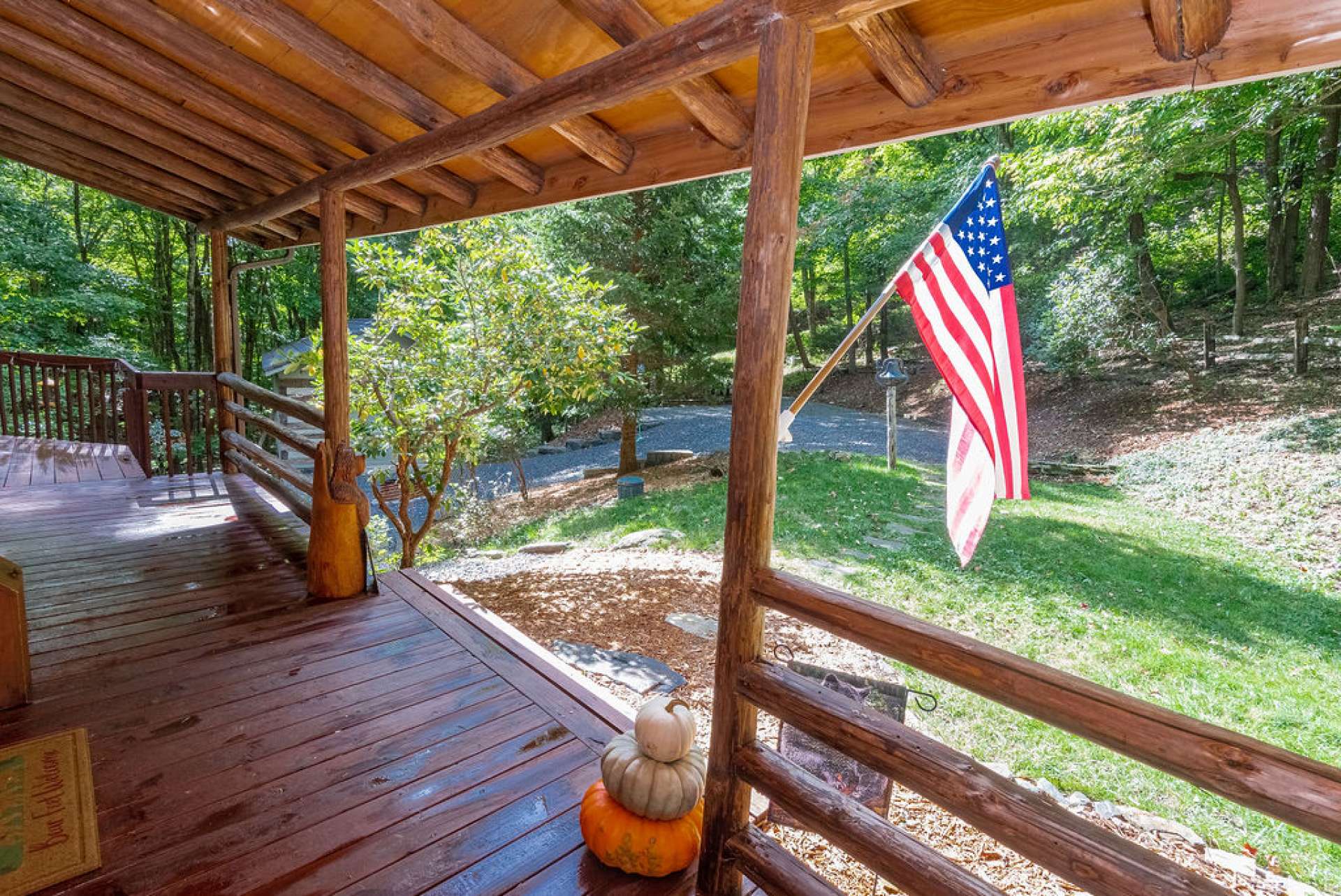 A covered front porch welcomes you and guests to enjoy true log cabin living.  From your front porch swing, all you see and hear is Nature's beauty.