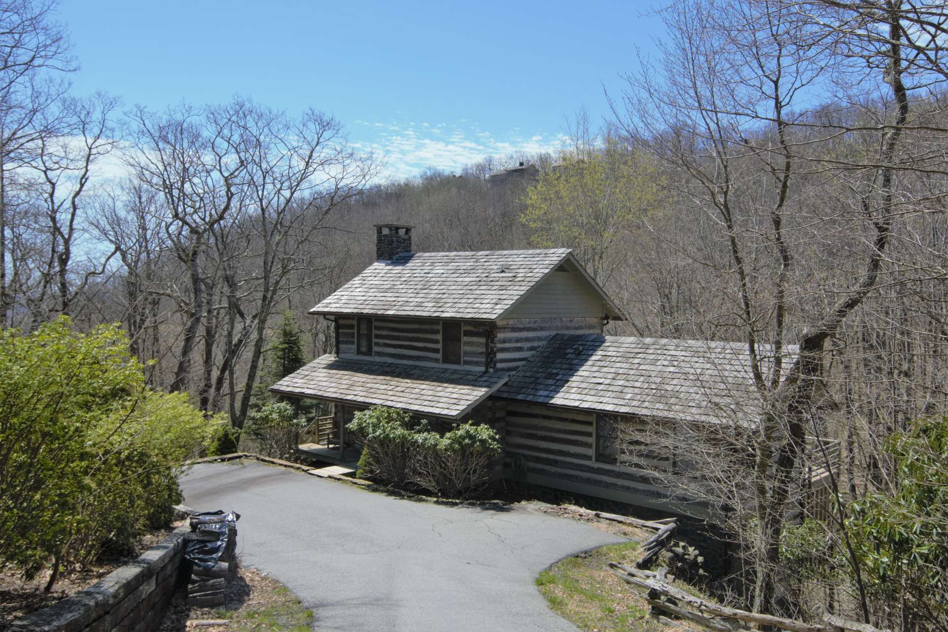 This truly unique and irresistible antique log cabin nestled among a wooded setting with creek in the charming log home community of Stonebridge in the Todd area of Southern Ashe County is offered at $429,000 and perfect for your Blue Ridge Mountain retreat.