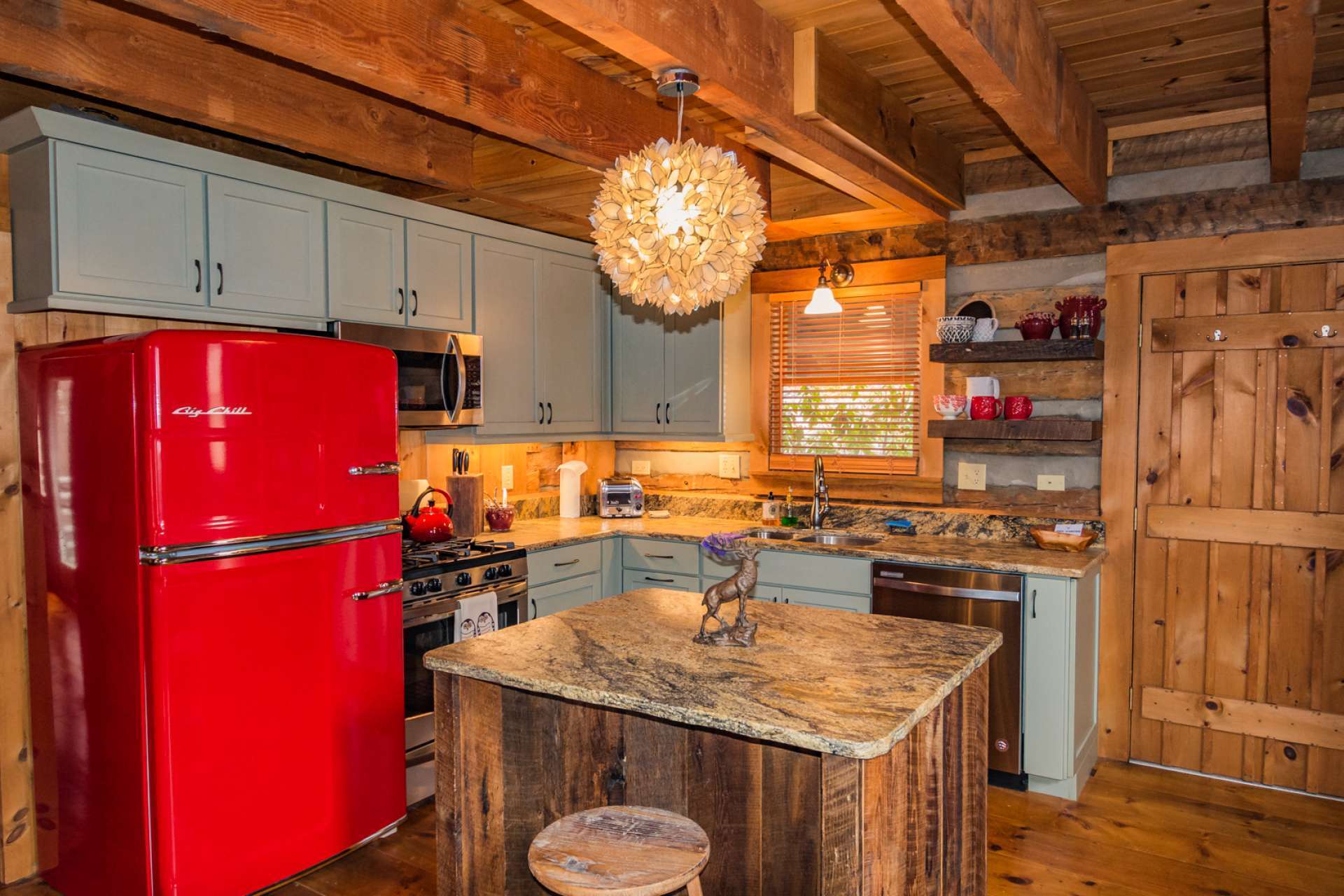 The new-fashioned kitchen features custom cabinets, a barn-wood island with leather granite tops, new stainless appliances with a gas range and a "Big Chill" refrigerator. This home exudes both charm and character.