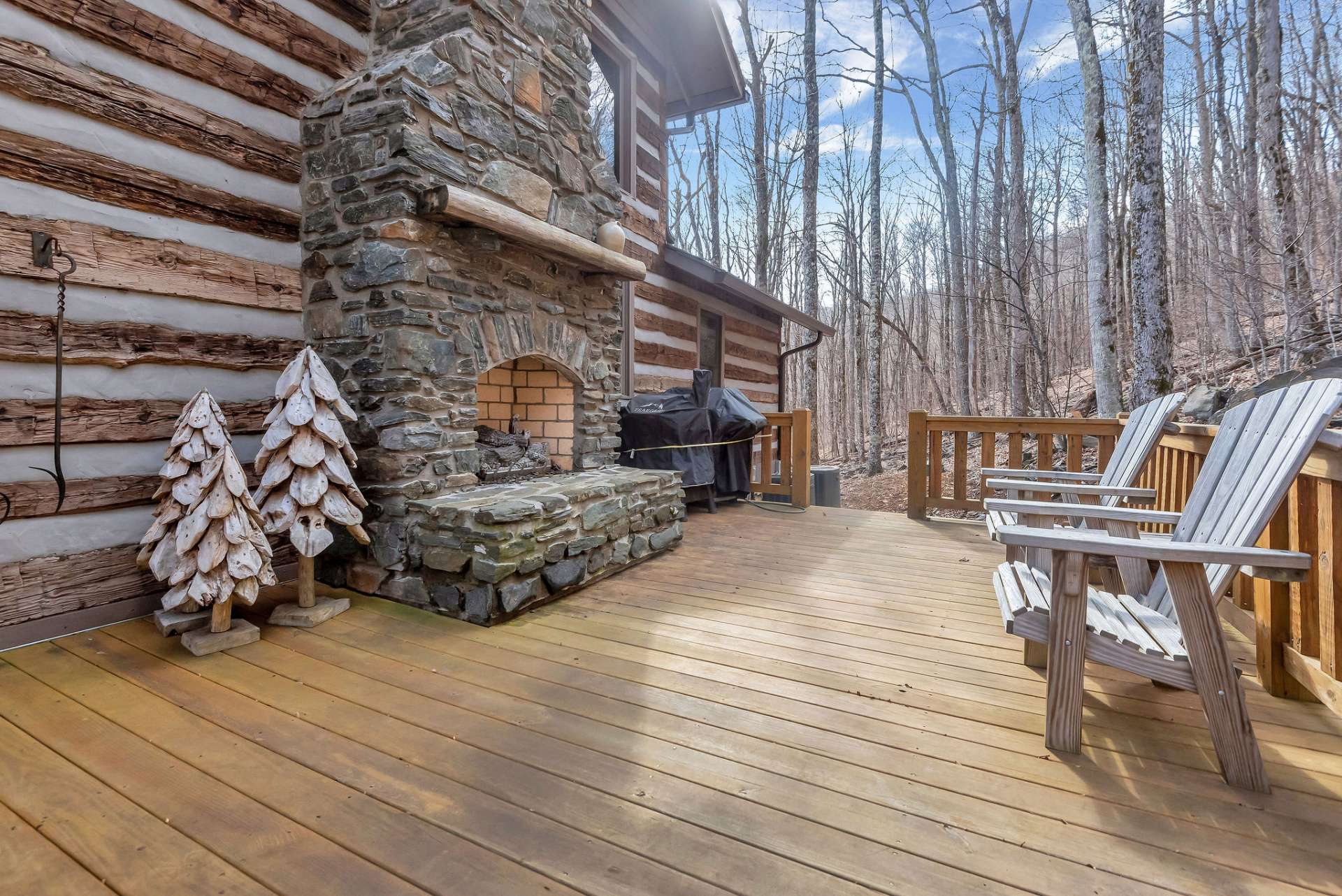 Enjoy the side deck, adorned with an outdoor stone fireplace, inviting your guests to linger late into the evening.