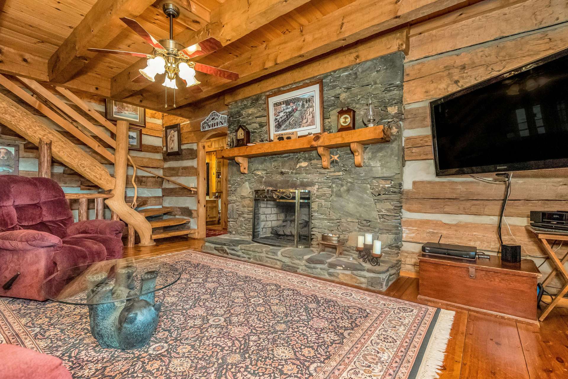 This is one of four stone fireplaces in this alluring log home.